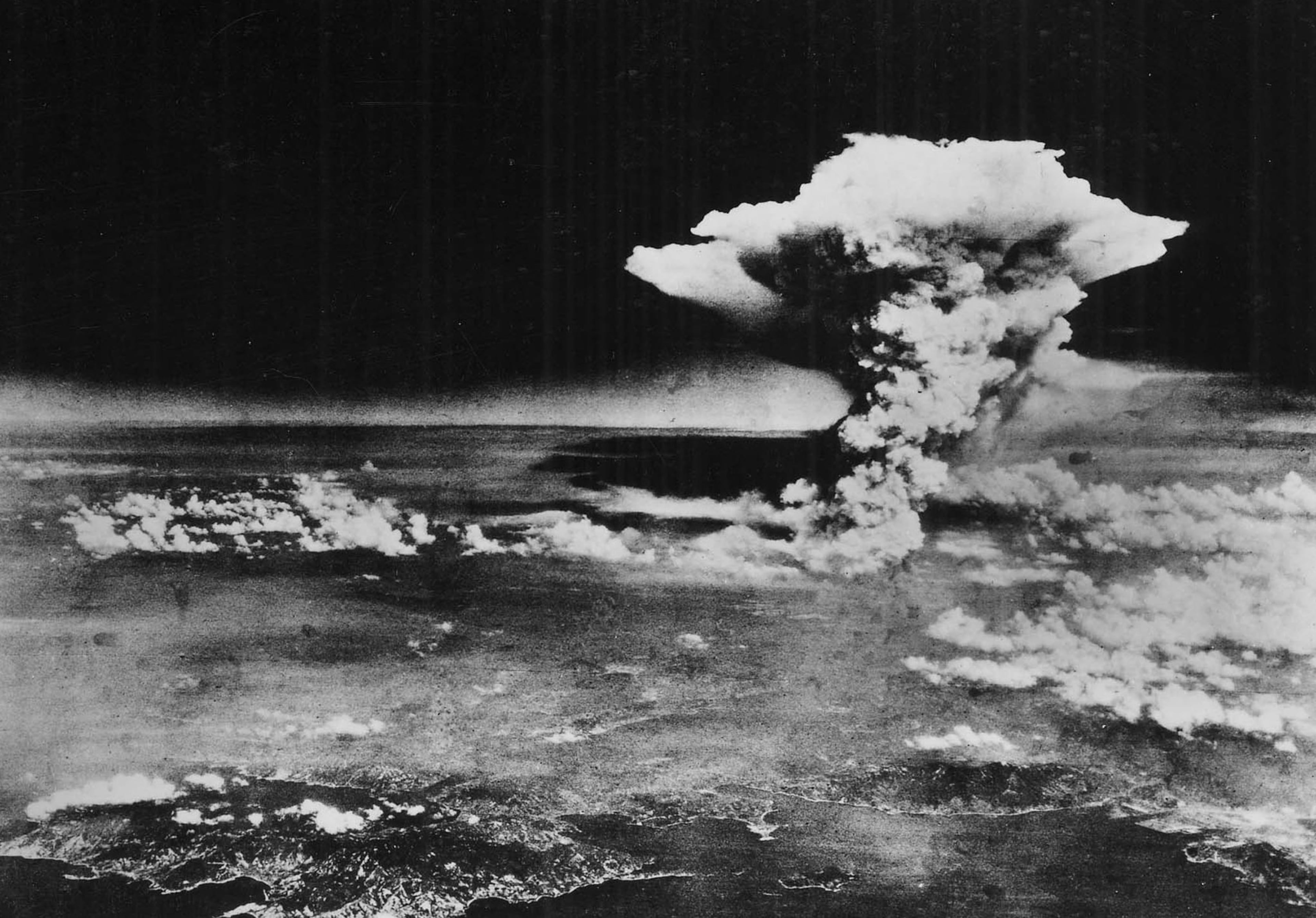 A mushroom cloud billows into the sky about one hour after an atomic bomb was detonated above Hiroshima, Japan.