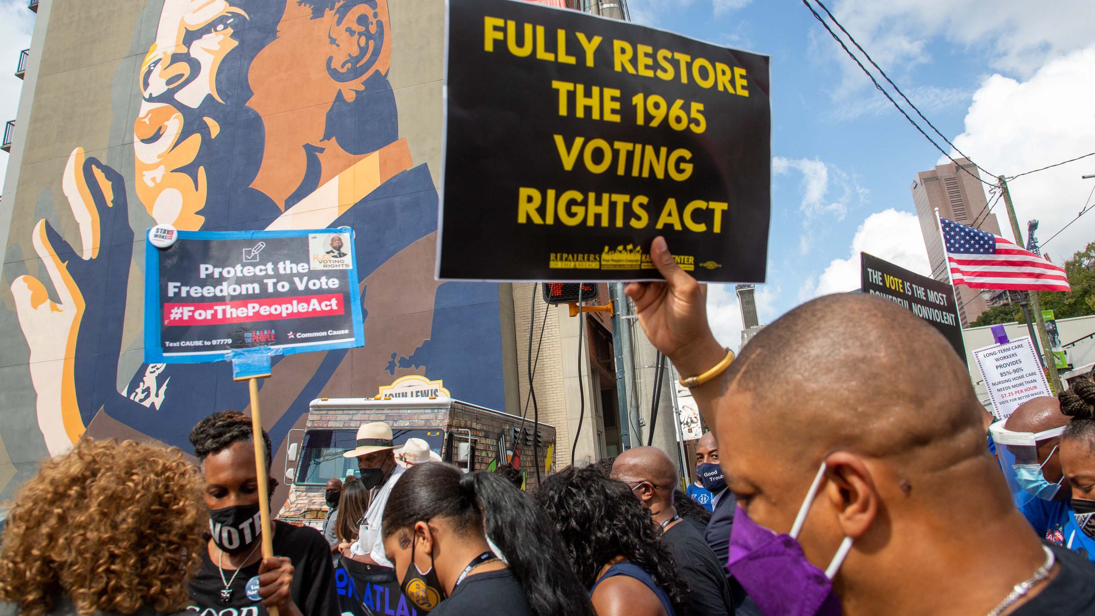 The March On For Voting Rights march reaches the John Lewis mural on Auburn Avenue in Atlanta on Saturday, August 28, 2021. STEVE SCHAEFER FOR THE ATLANTA JOURNAL-CONSTITUTION