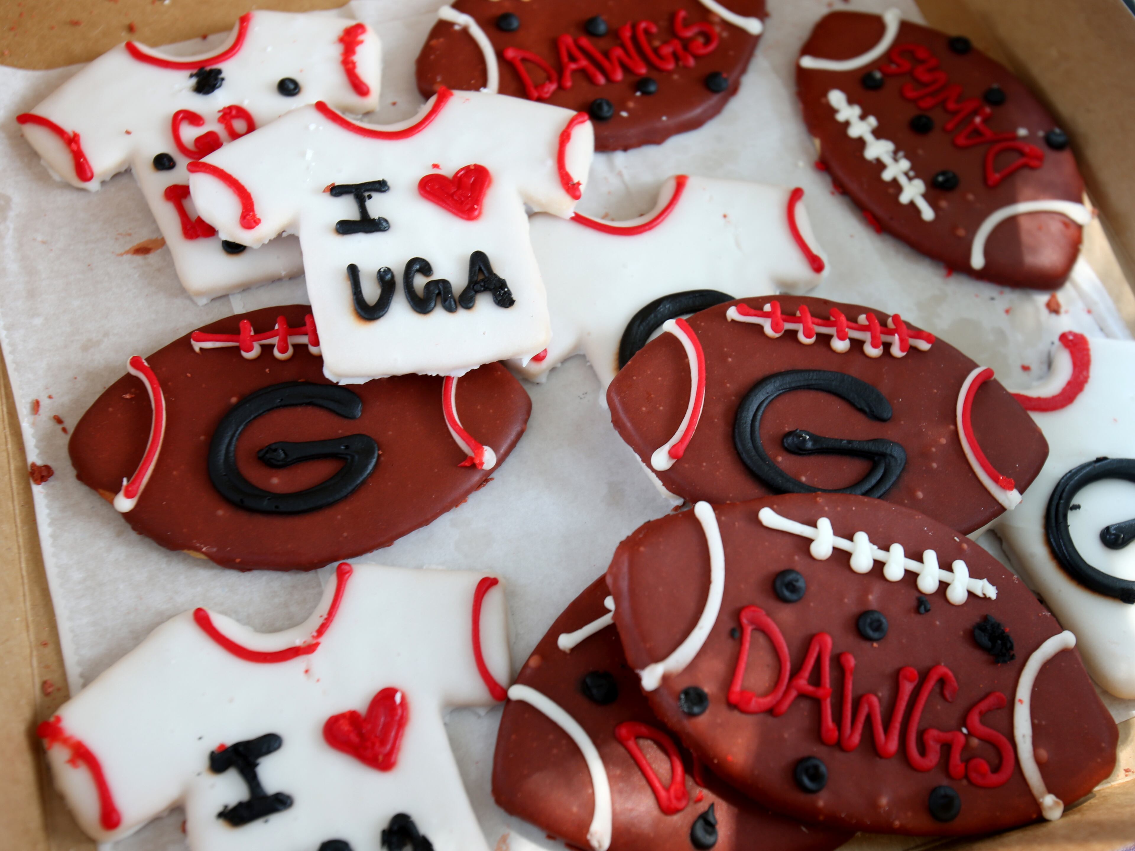 Patricia Andrews, of Alpharetta, displays her Georgia-inspired cookies before Georgia plays Clemson on Saturday. Patricia is the mother of Georgia's starting center, David Andrews. JASON GETZ / JGETZ@AJC.COM