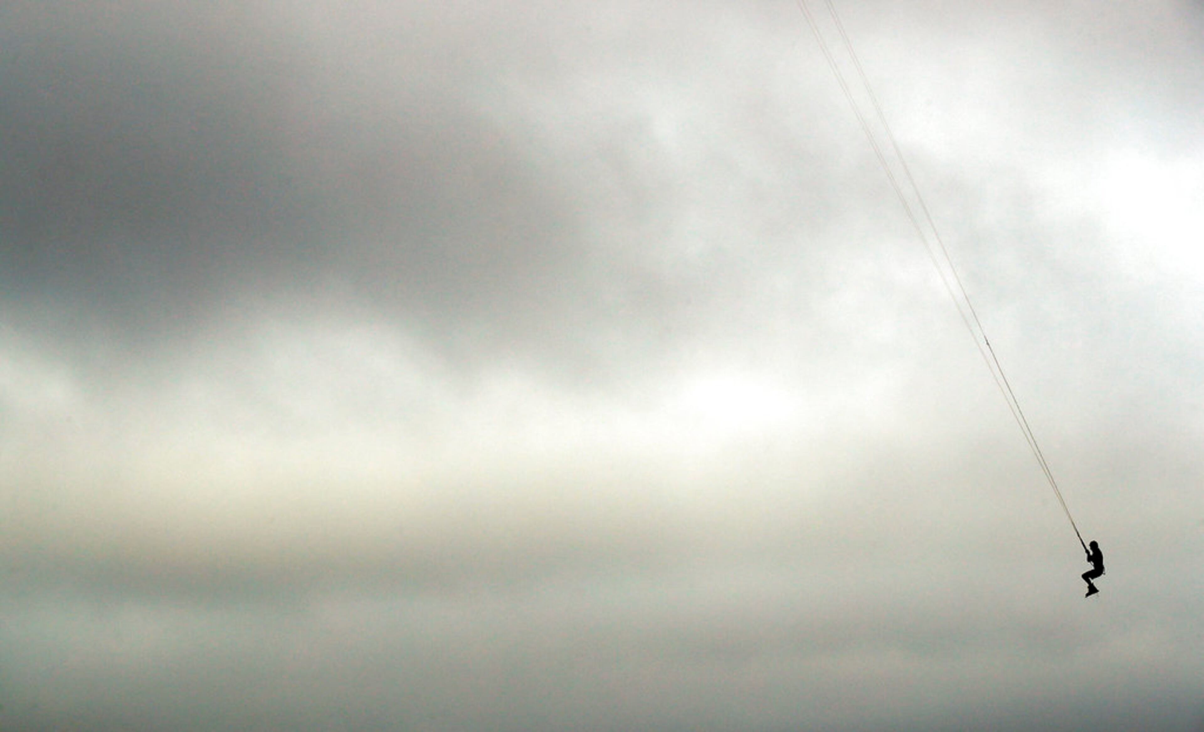 Bob Bowman, from Virginia Beach, Va., gets some air as he kiteboards, Thursday, Sept. 13, 2018, in Virginia Beach, Va., as Hurricane Florence moves towards the eastern shore. (AP Photo/Alex Brandon)