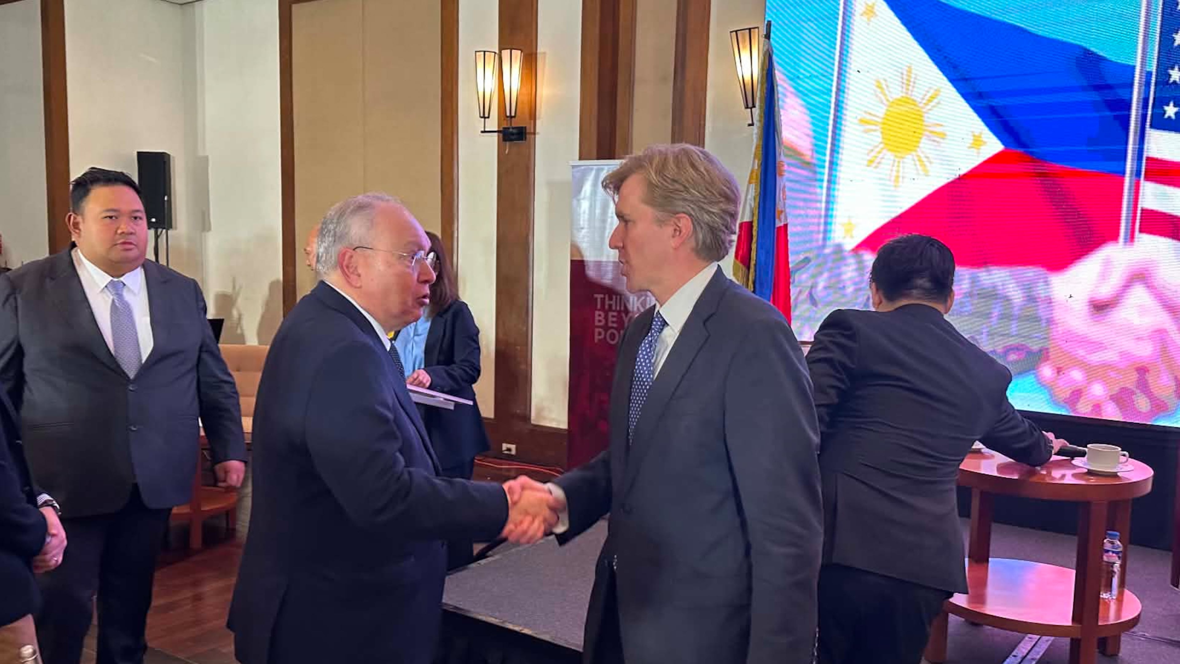 United States Undersecretary of Defense for Policy Elbridge Colby, right, shakes hands with Philippine Ambassador to the U.S., Jose Manuel Romualdez during a forum in Manila, Philippines on Monday, Aug. 10, 2026. (AP Photo/Joeal Calupitan)
