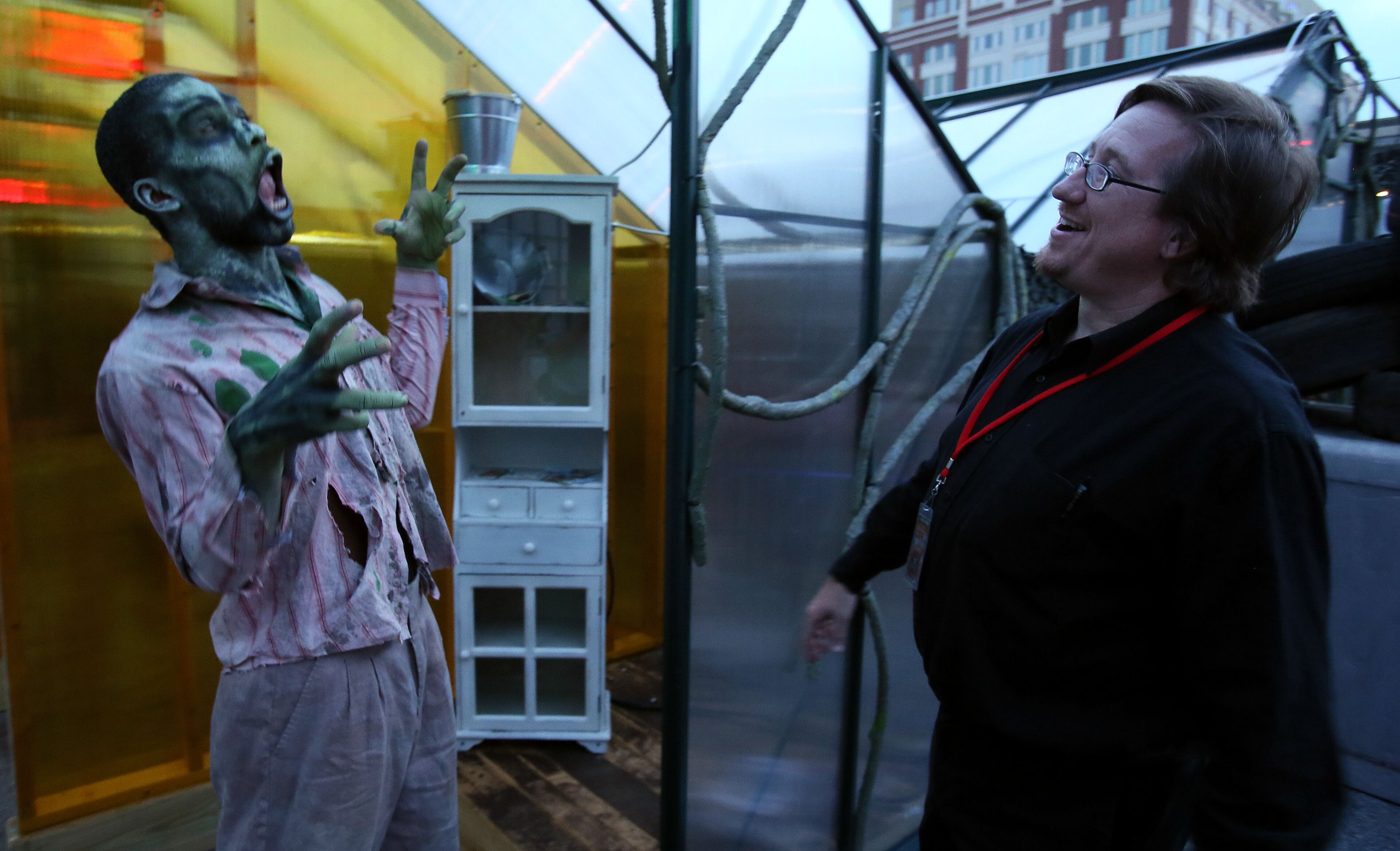 Zombie Sean Rumph (left) & Charles Bailey prepare for the opening of "Containment," Atlanta's newest giant haunted house at Atlantic Station on Wednesday October 2nd, 2013. All employees participated in Containment Crew University to learn about the operation of Containment. The crew of 43 actors chosen from the hundreds that auditioned learned everything about how it operates, makeup, costuming, how to scare people and what to do if someone reacts badly to being scared. Containment, housed on 20 containers underneath Atlantic Station, runs from October 4th-November 3rd. PHIL SKINNER / PSKINNER@AJC.COM