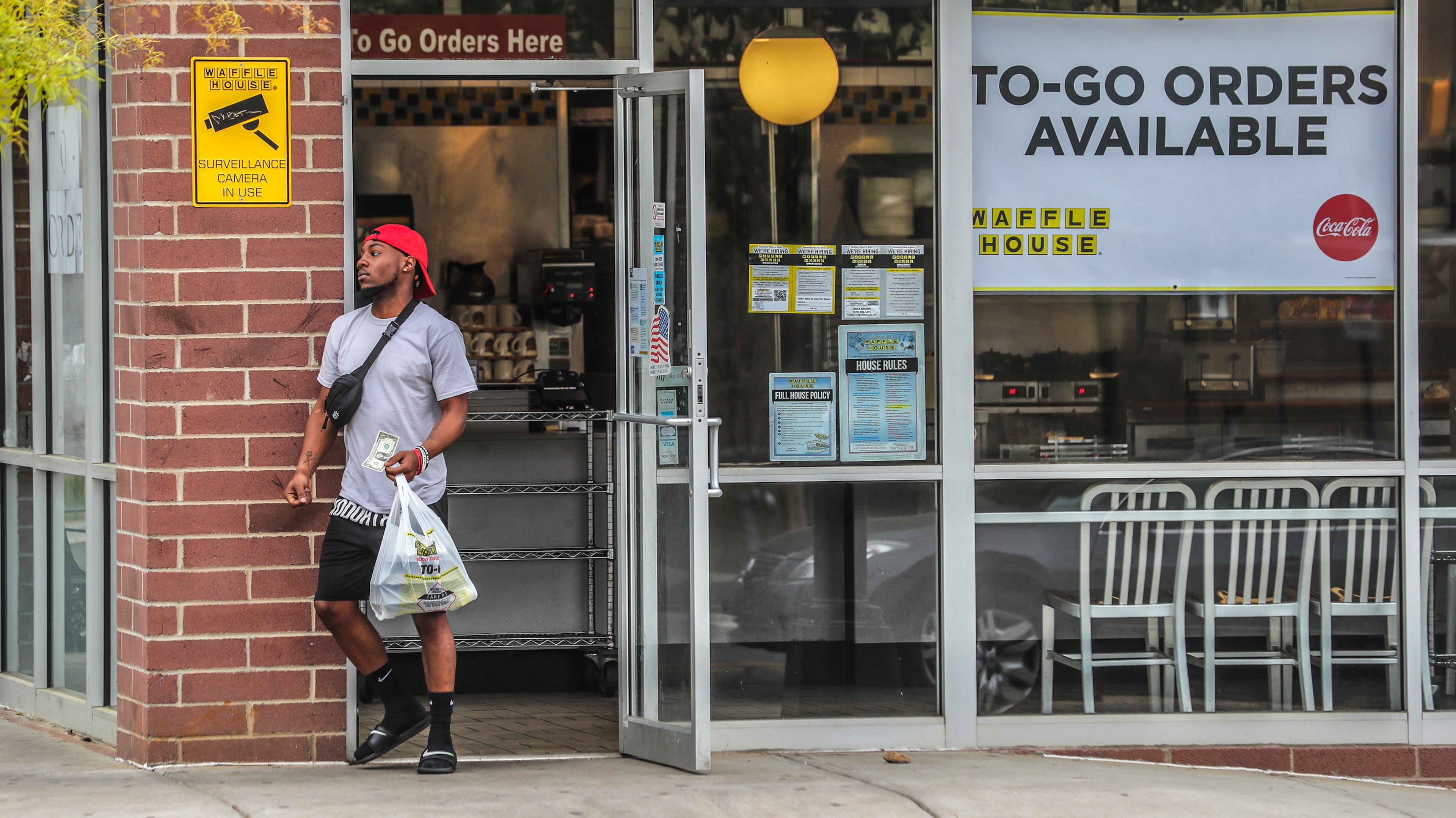 April 8, 2020 Atlanta: Karriem Patrick gets his To-Go food from the Waffle House at 860 Glenwood Ave SE in Atlanta on Wednesday, April 8, 2020. Gov. Brian Kemp said Wednesday he would extend GeorgiaâÃôs public health emergency through May 13, granting him more time to use extraordinary powers to suspend laws and impose other restrictions to contain the coronavirus pandemic. The extension prolongs the governorâÃôs authority to take âÃúdirectâÃù control of civil staffers, restrict travel, limit public gatherings and institute a range of other measures to combat the disease. JOHN SPINK/JSPINK@AJC.COM