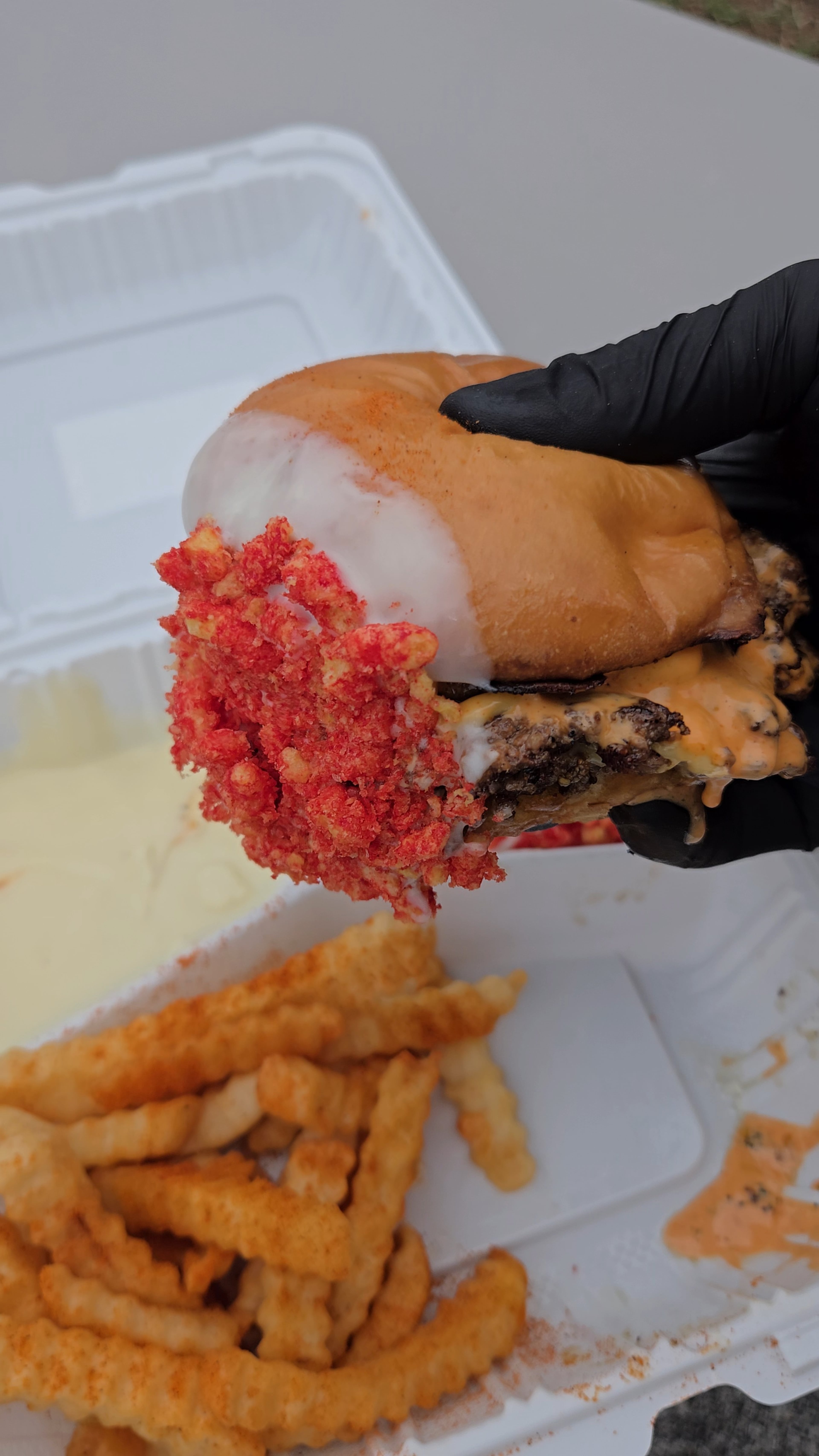Burtgers’ double burger with Moose's original sauce, cheese bath and Flamin' Hot Cheetos crumbs. (Courtesy of Bert Bounnakhom)