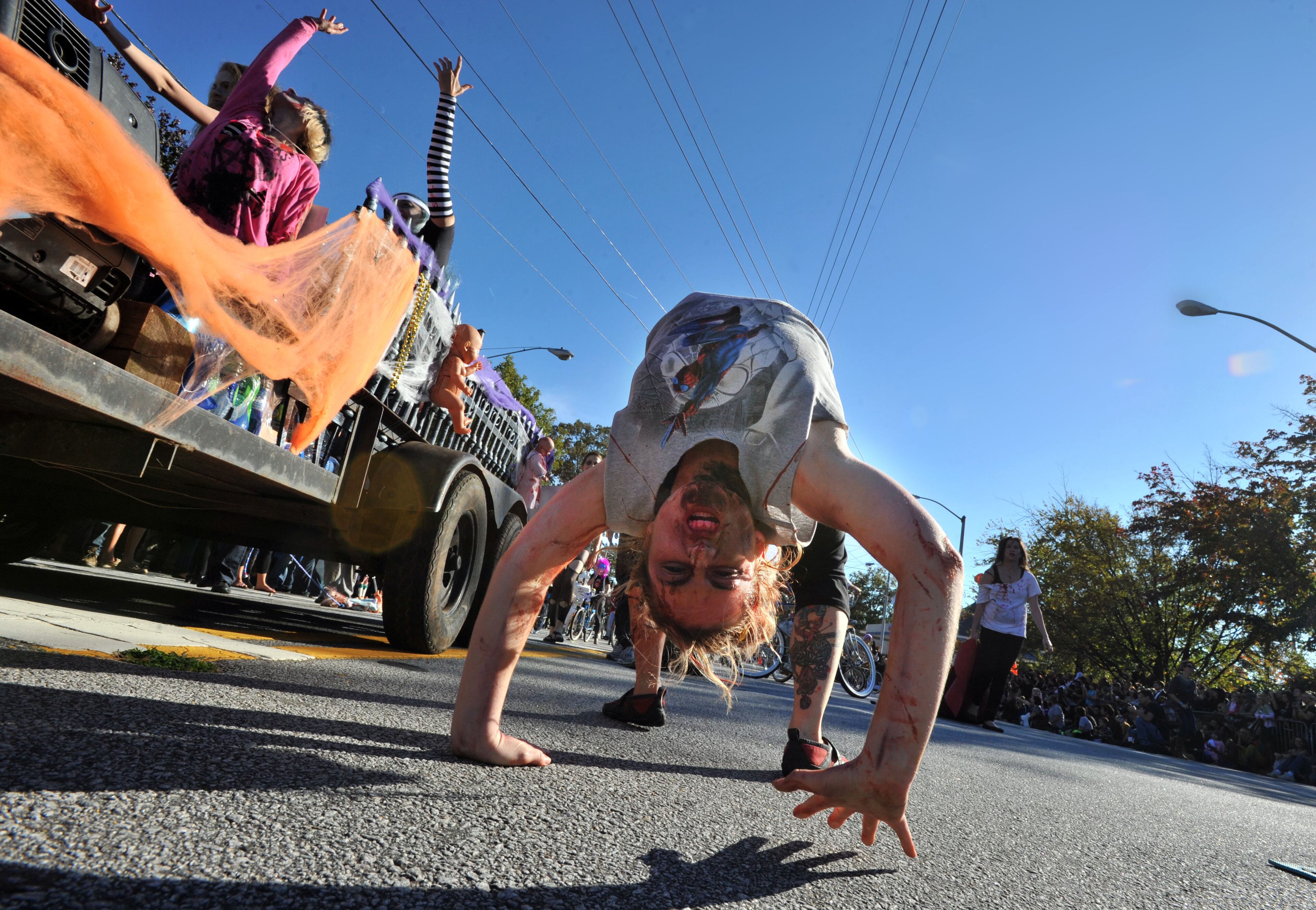A parade participant from Tough Love Yoga shows some flexibility during the Little Five Points Halloween Parade.