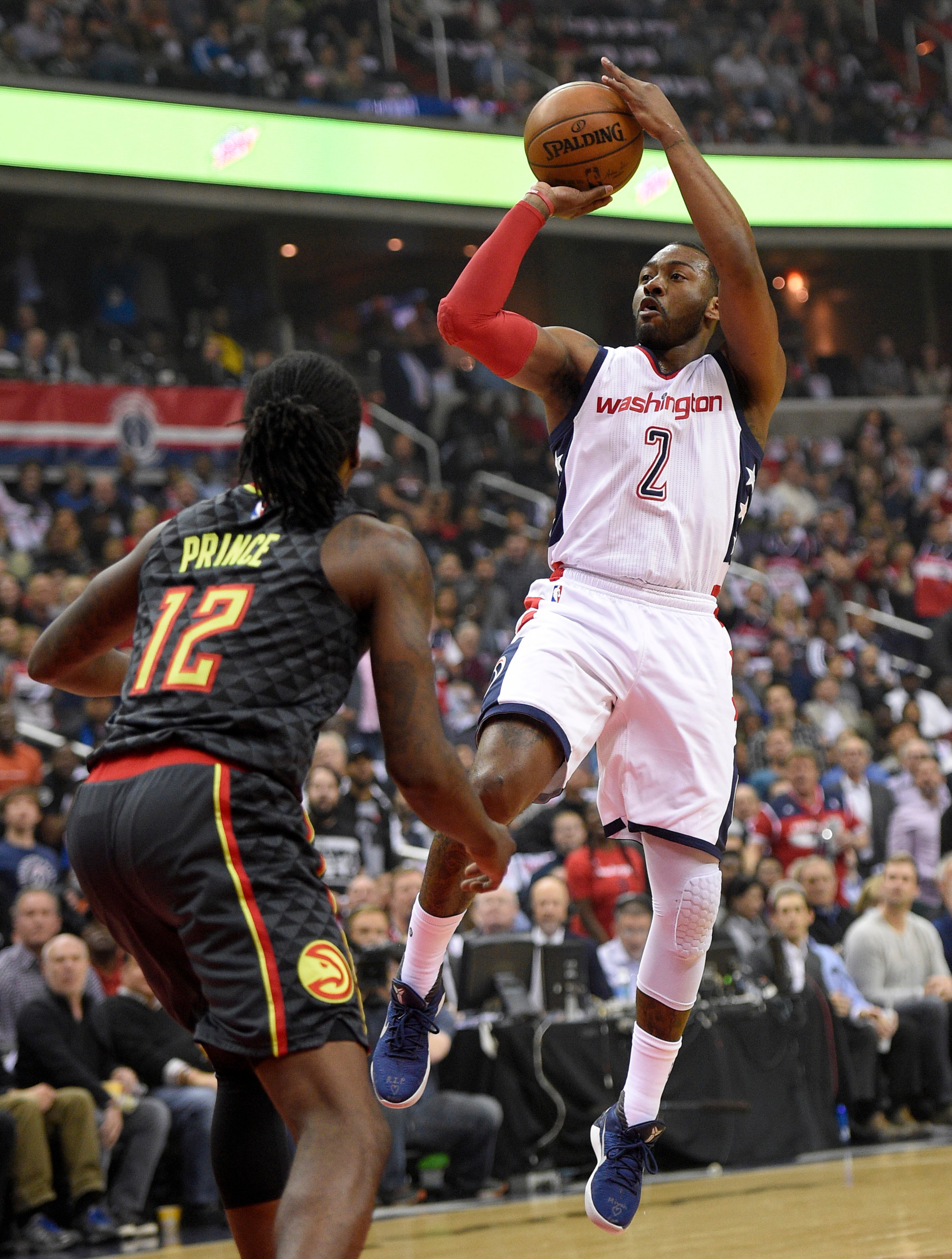 Washington Wizards guard John Wall (2) shoots against Atlanta Hawks forward Taurean Prince (12) during the first half in Game 2 of a first-round NBA basketball playoff series, Wednesday, April 19, 2017, in Washington. (AP Photo/Nick Wass)