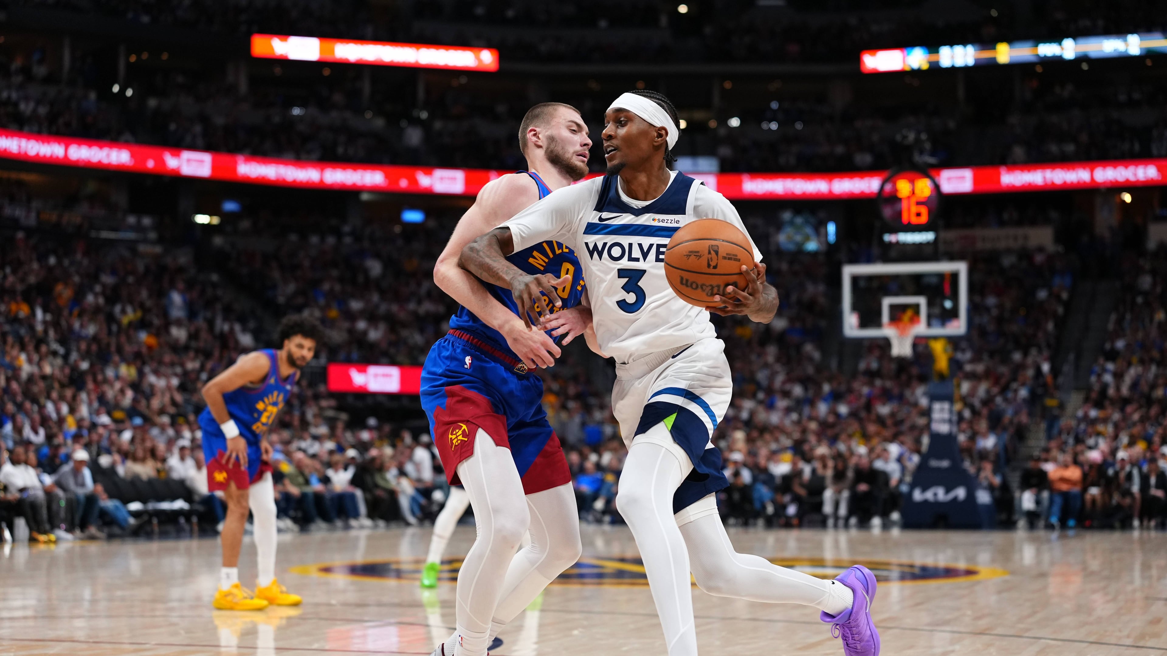 Minnesota Timberwolves Jaden McDaniels (3) drives to the basket against Denver Nuggets guard Christian Braun (0) during the second half in Game 2 of a first-round NBA playoffs basketball series Monday, April 20, 2026, in Denver. (AP Photo/Jack Dempsey) CORRECTION Correct to Julius Randle in stead of Julius Randle.