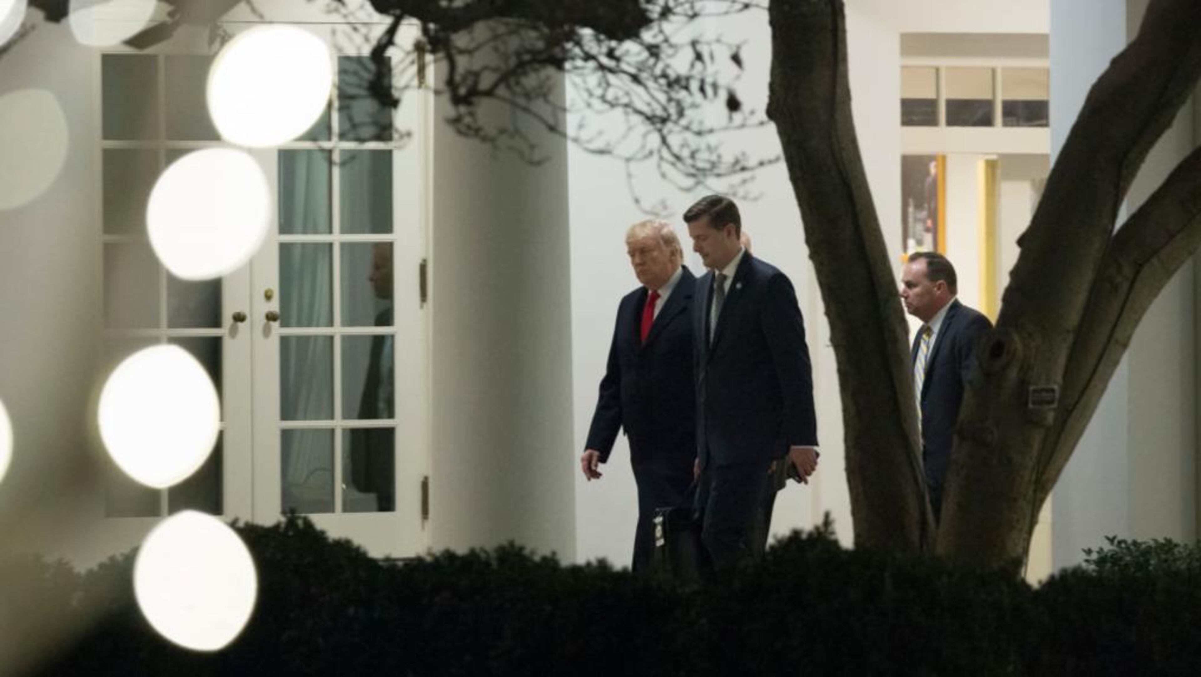 President Donald Trump speaks with White House Staff Secretary Rob Porter (C) and Sen. Mike Lee (R-UT) (R) as they return to the White House December 4, 2017 in Washington, DC. President Trump traveled to Utah to announce his plan to shrink the Bears Ears and Grand Staircase-Escalante national monuments.