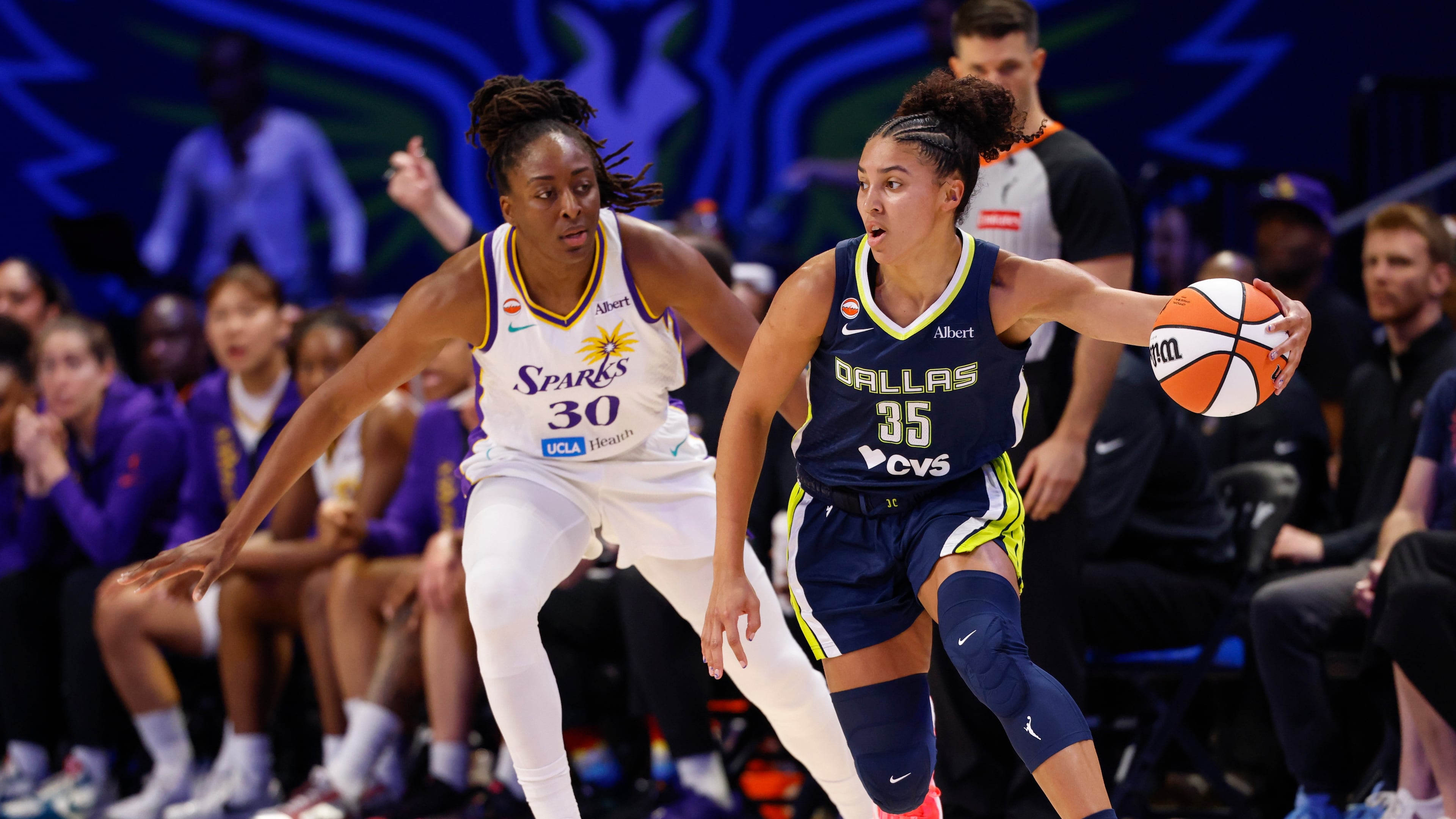 Dallas Wings guard Azzi Fudd (35) dribbles against Los Angeles Sparks forward Nneka Ogwumike (30) during the first half of a WNBA basketball game, Sunday, July 19, 2026, in Arlington, Texas. (Elías Valverde II/The Dallas Morning News via AP)