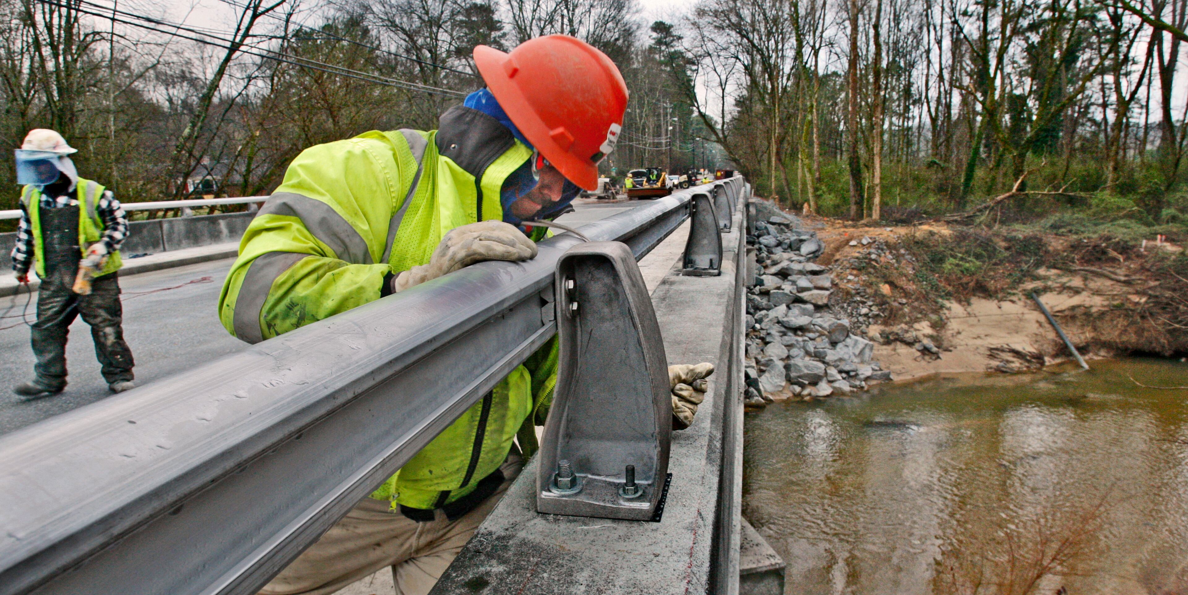 A construction worker works on the Peachtree Dunwoody bridge over Nancy Creek on March 23, 2010. John Spink, jspink@ajc.com