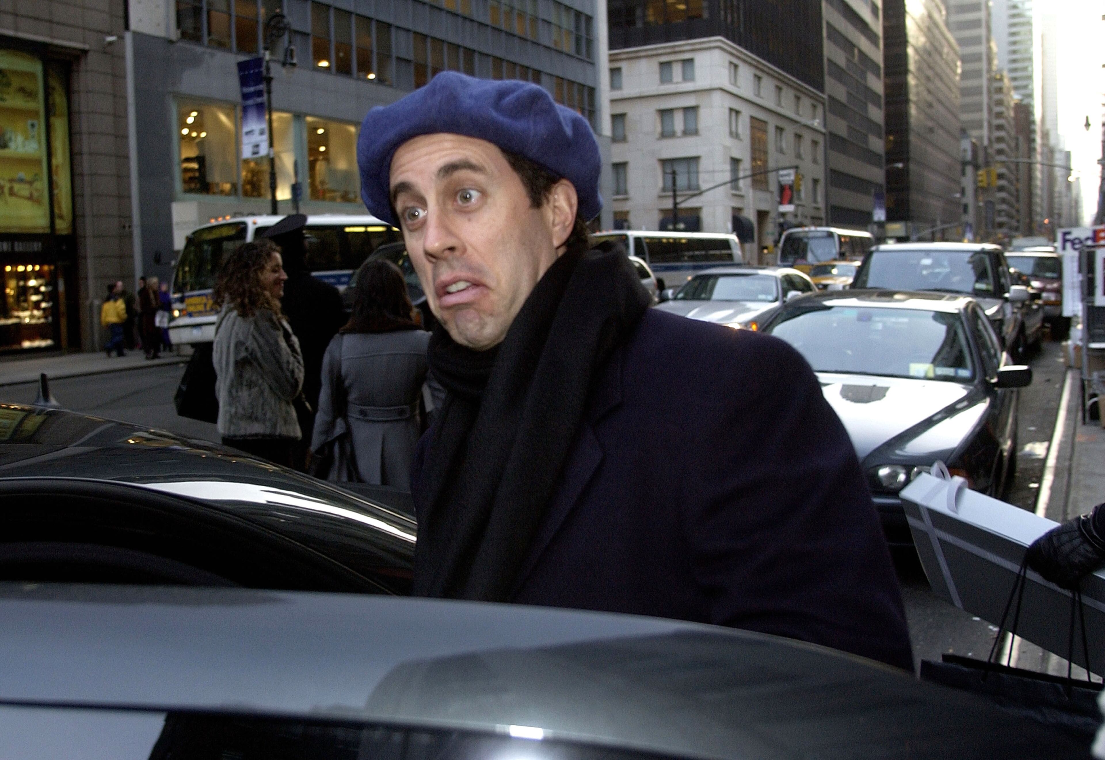 Actor/Comedian Jerry Seinfeld leaves Barney's after shopping with his wife Jessica Sklar December 4, 2002 in New York City. (Photo by Mark Mainz/Getty Images)