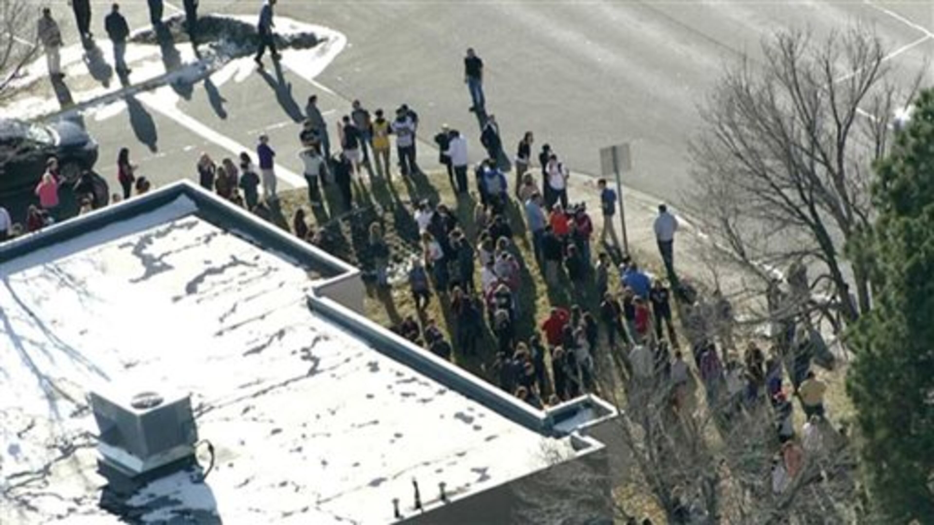 In this still image taken from video provided by Fox 31 Denver, students gather just outside of Arapahoe High School as police respond to reports of a shooting at Arapahoe High School in Centennial, Colo. Friday, Dec. 13, 2013. Colorado division of emergency management spokeswoman Micki Trost said her director went to the school and their weren't any more immediate details. (AP Photo/KDVR)