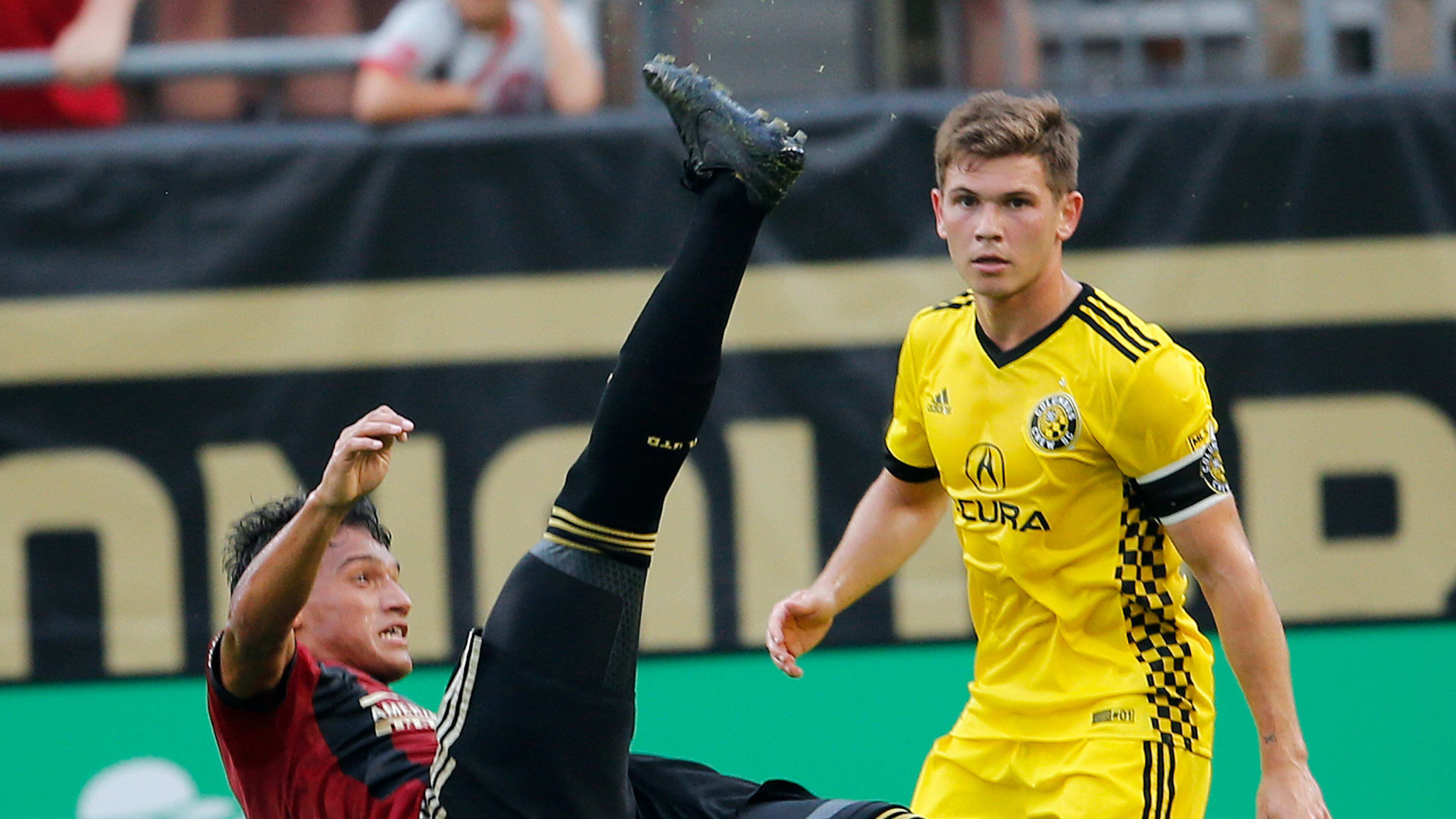 Atlanta United midfielder Yamil Asad (11) takes a shot on goal as Columbus Crew midfielder Will Trapp (20) looks on in the first half of an MLS soccer match, Saturday, June 17, 2017, in Atlanta (AP Photo/John Bazemore)