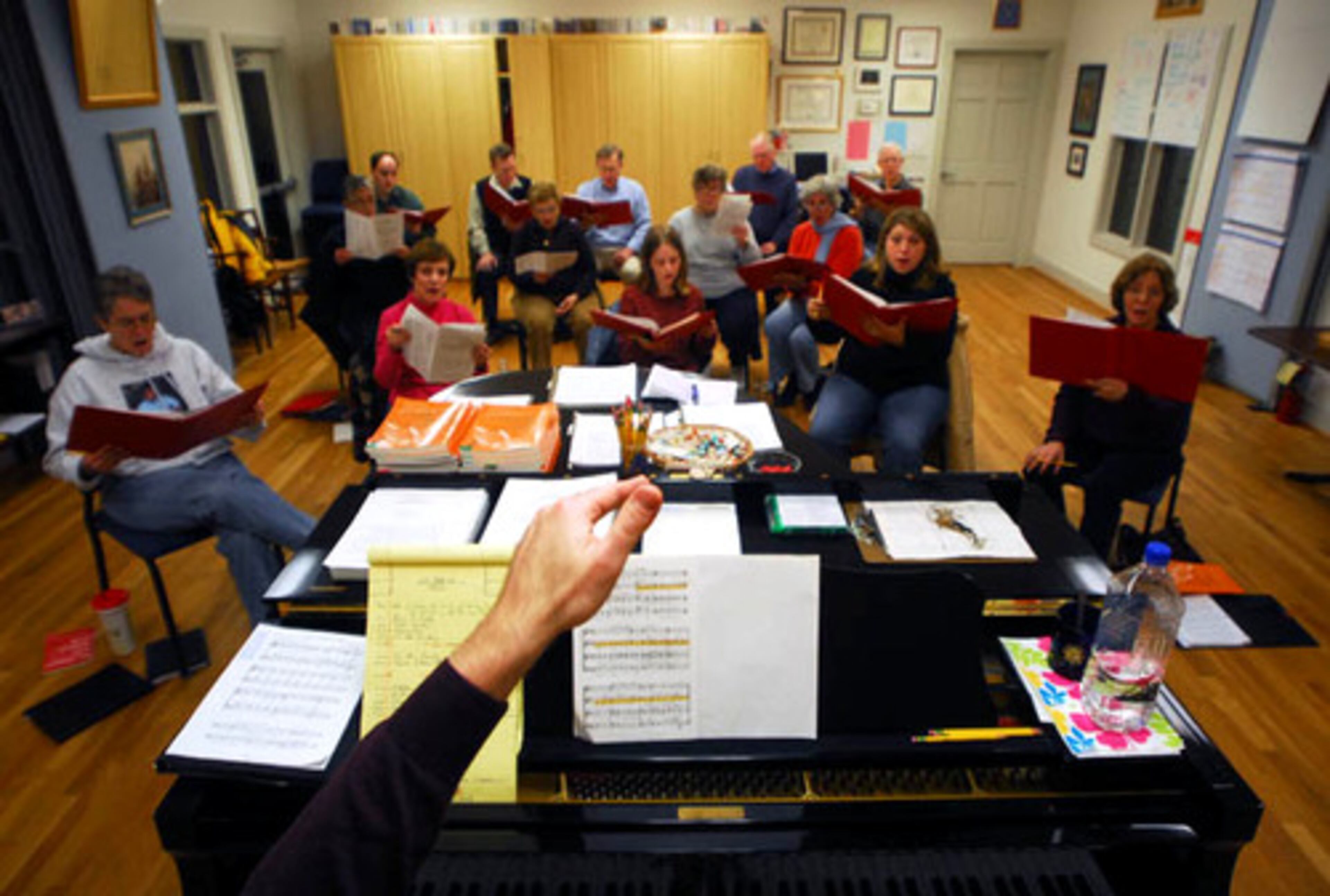 Organist and Choirmaster Stephen L. Furches raises his hand to direct the St. Dunstan's Episcopal church during choir practice.