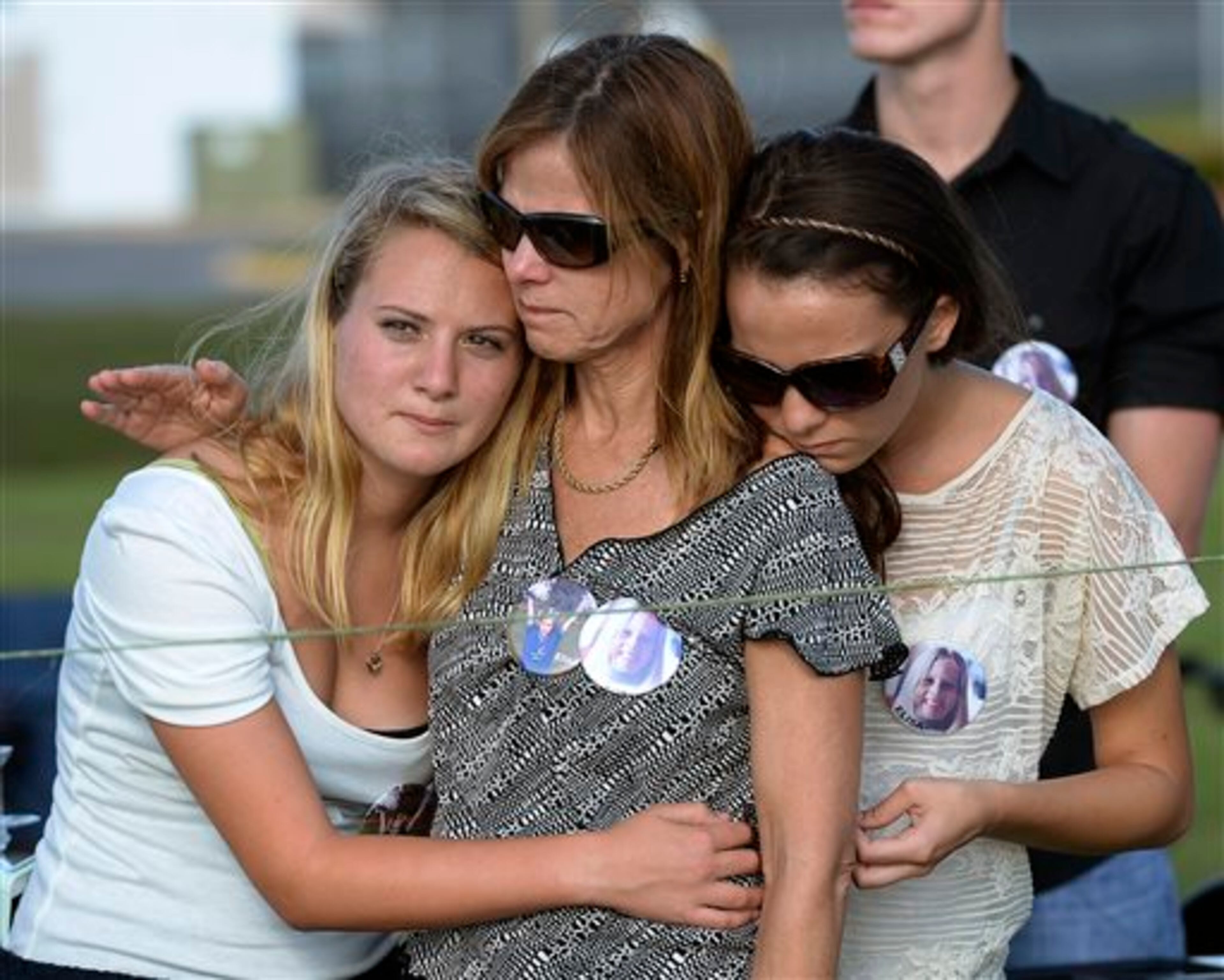 Demonstrators console each other across the highway from the Florida State Correctional facility near Starke, Fla., Wednesday, April 10, 2013, as they await the execution of Larry Eugene Mann. Mann was sentenced to death for the 1980 abduction and murder of 10-year-old Elisa Vera Nelson as she rode her bike to school. Mann was pronounced dead at 7:19 p.m. Eastern on Wednesday following a lethal injection. (AP Photo/Phil Sandlin)
