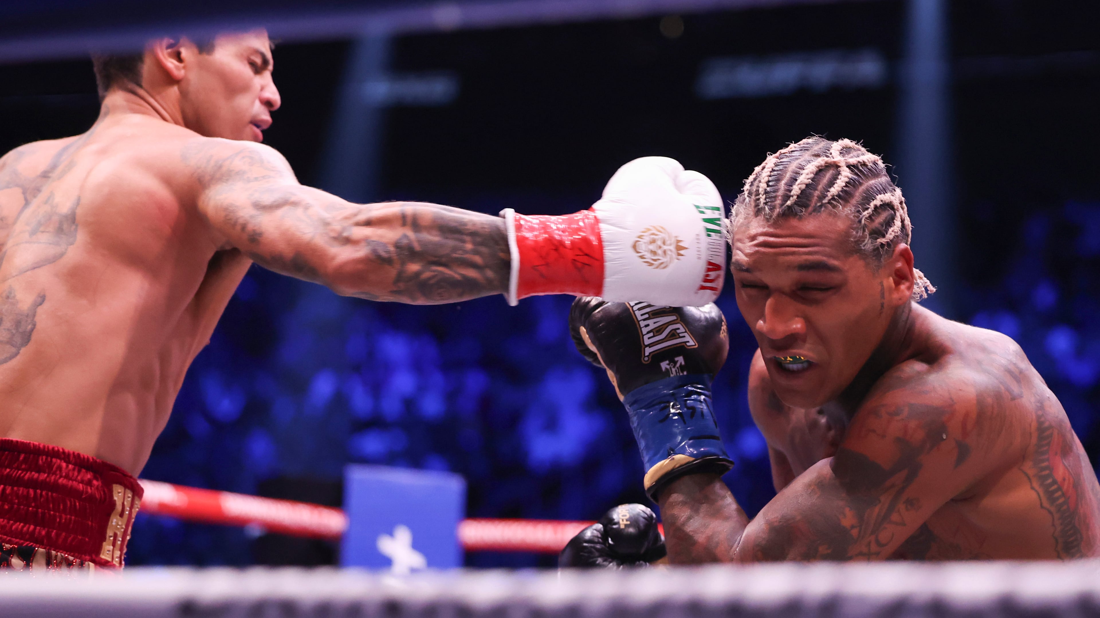 Ryan Garcia, left, punches Conor Benn in their welterweight championship fight Saturday, Sept. 12, 2026, in Las Vegas. (AP Photo/Ian Maule)