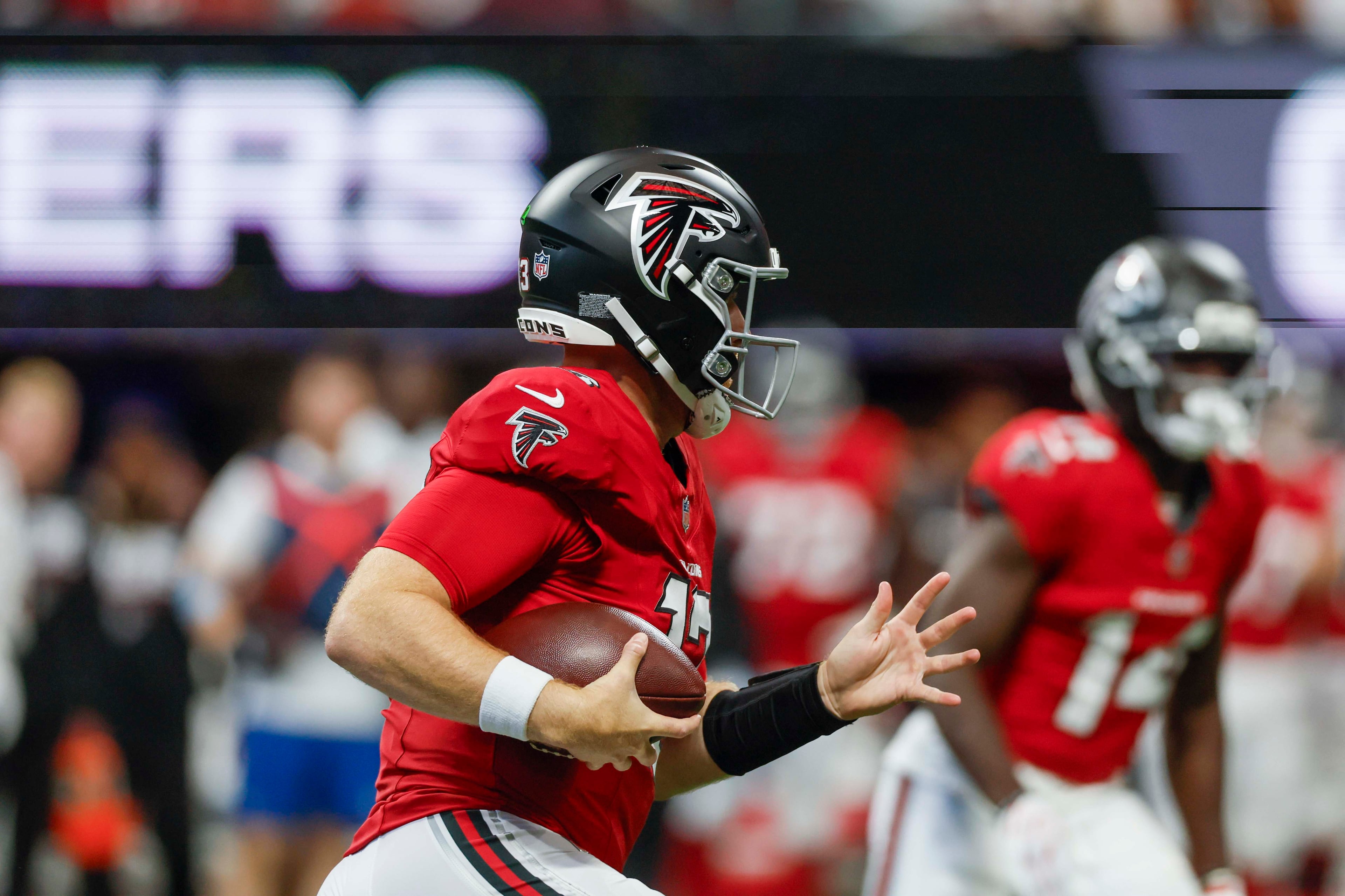Atlanta Falcons quarterback Cooper Rush (13) rushes with the ball on his first play, just before a fumble, during the first half of an NFL football game against the Carolina Panthers at Mercedes-Benz Stadium in Atlanta on Sunday, September 20, 2026. (Miguel Martinez/AJC)