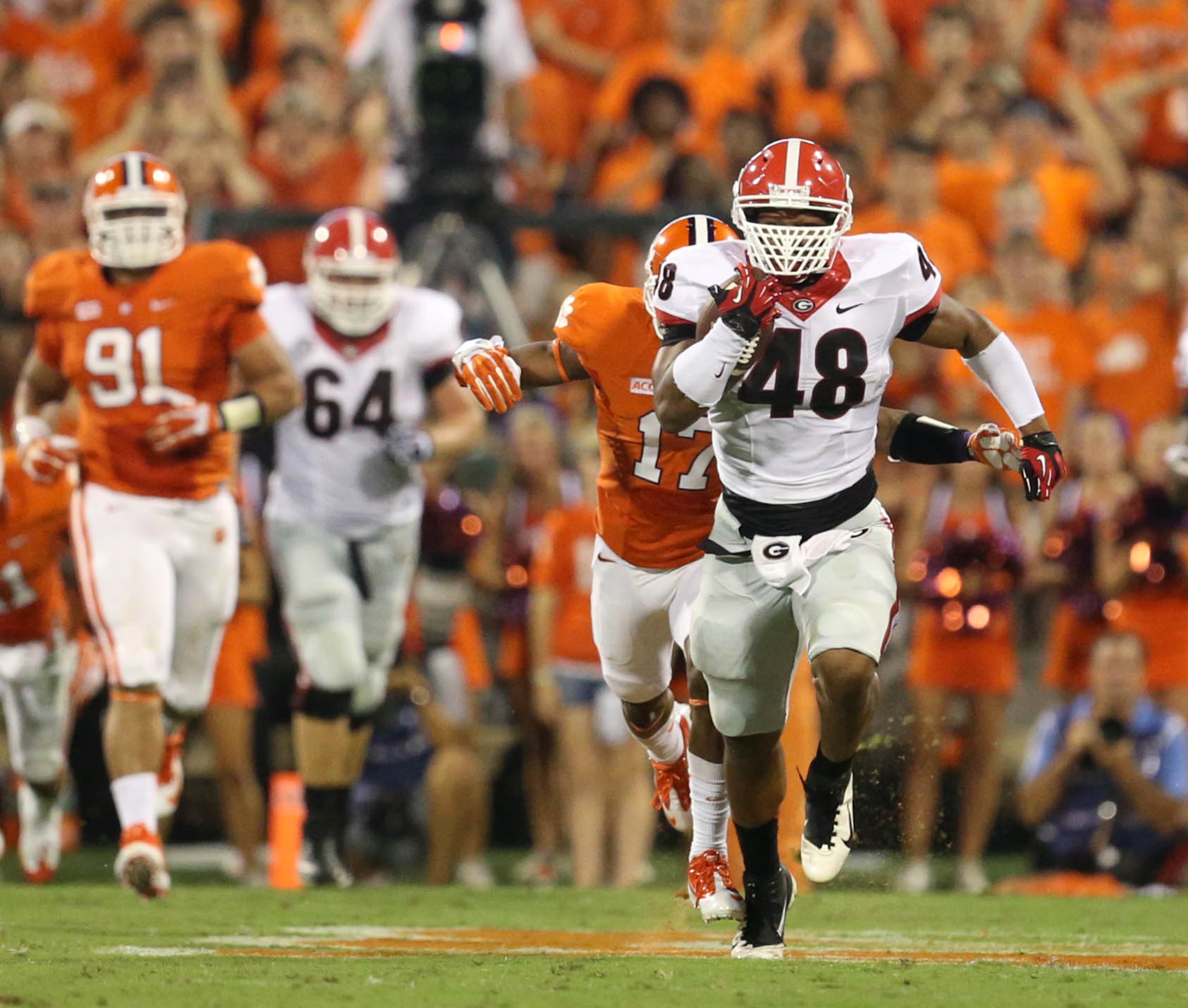 Georgia fullback Quayvon Hicks (48) gets tackled by Clemson University defender Bashaud Breeland (17) after a long run by Hicks in the first half of their game at Clemson University at Memorial Stadium Saturday night in Clemson, SC., August 31, 2013. JASON GETZ / JGETZ@AJC.COM