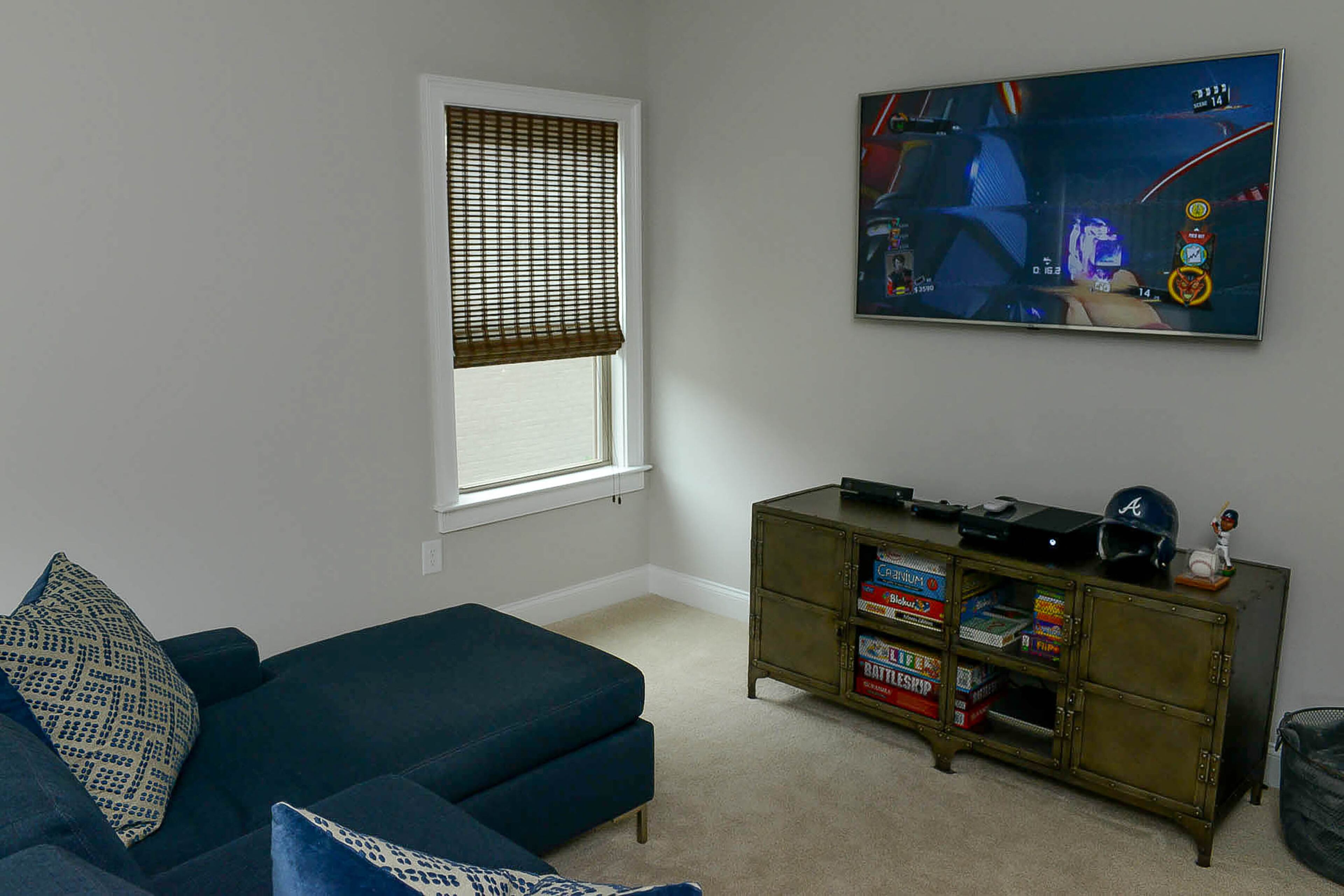 From the custom sectional, 14-year-old Luke can play video games in the upstairs game room.