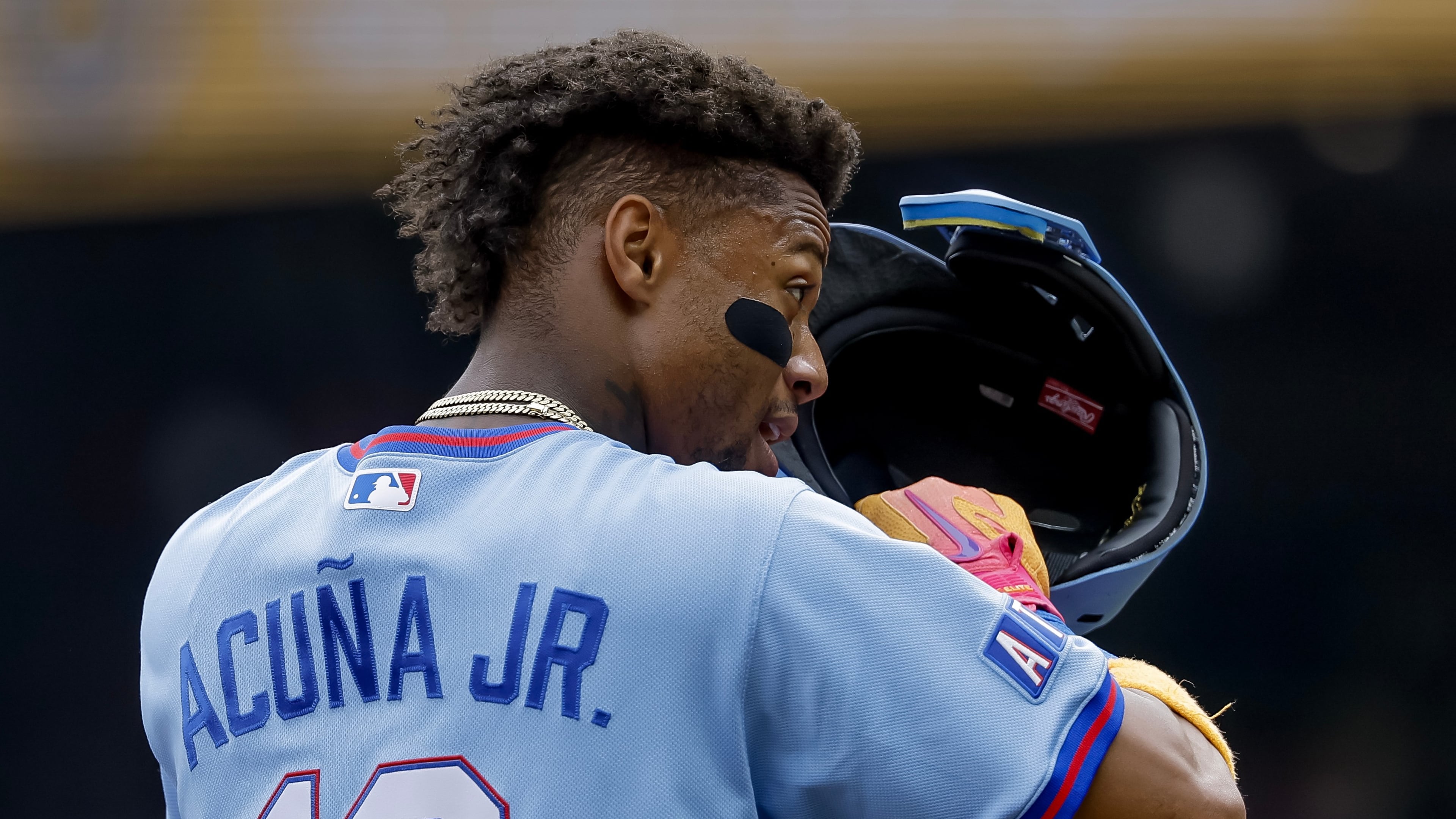 Atlanta Braves' Ronald Acuna Jr. adjusts his helmet while standing on third base against the Pittsburgh Pirates during the first inning of a baseball game, Saturday, June 6, 2026, in Atlanta. (AP Photo/Erik S. Lesser)