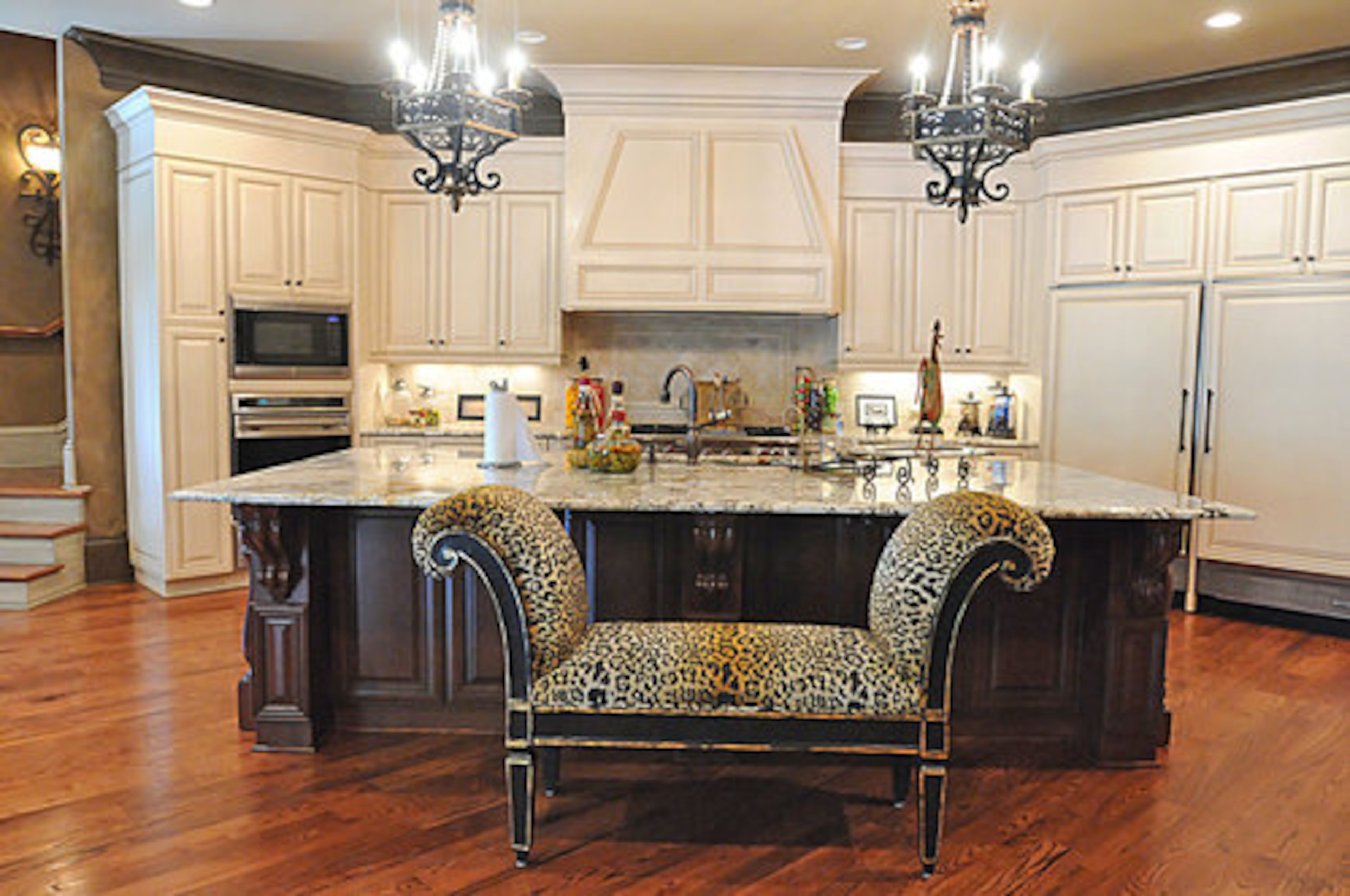 The main kitchen has a catering room and butler's pantry with a dishwasher that's located between the kitchen and the formal dining room. All of the appliances are discreetly housed in cabinetry. There's also a morning kitchen off the master bedroom.