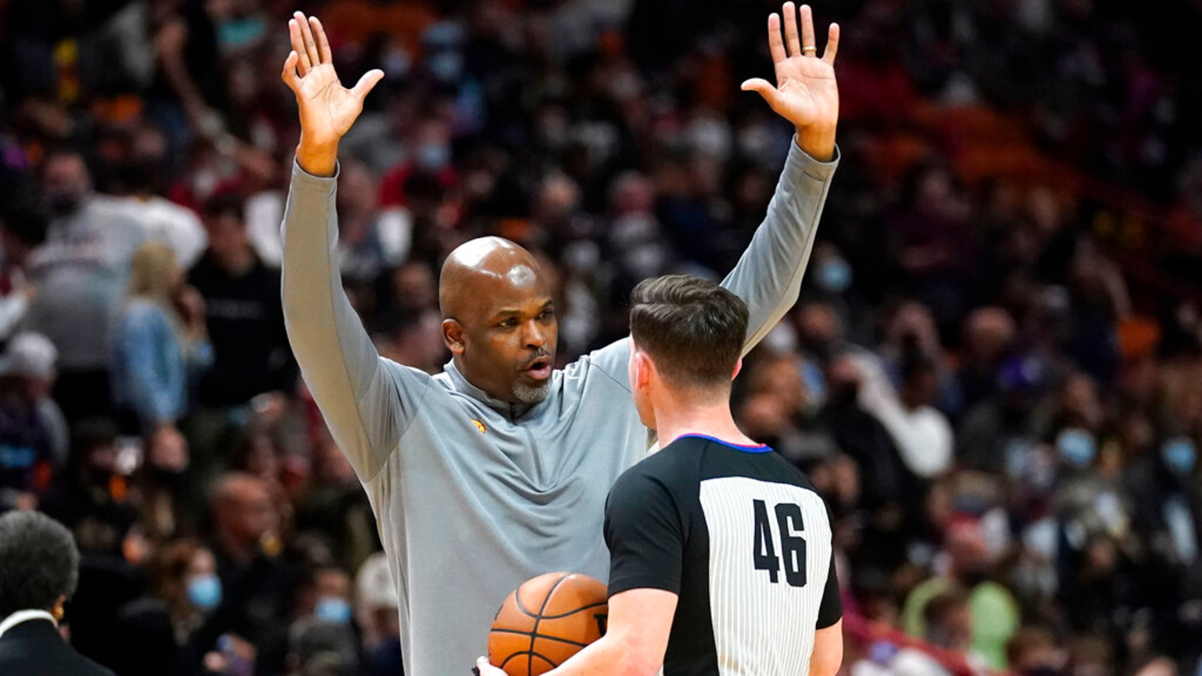 Atlanta Hawks head coach Nate McMillan, left, argues a call with official Ben Taylor (46) during the first half of an NBA basketball game against the Miami Heat, Friday, Jan. 14, 2022, in Miami. (AP Photo/Lynne Sladky)