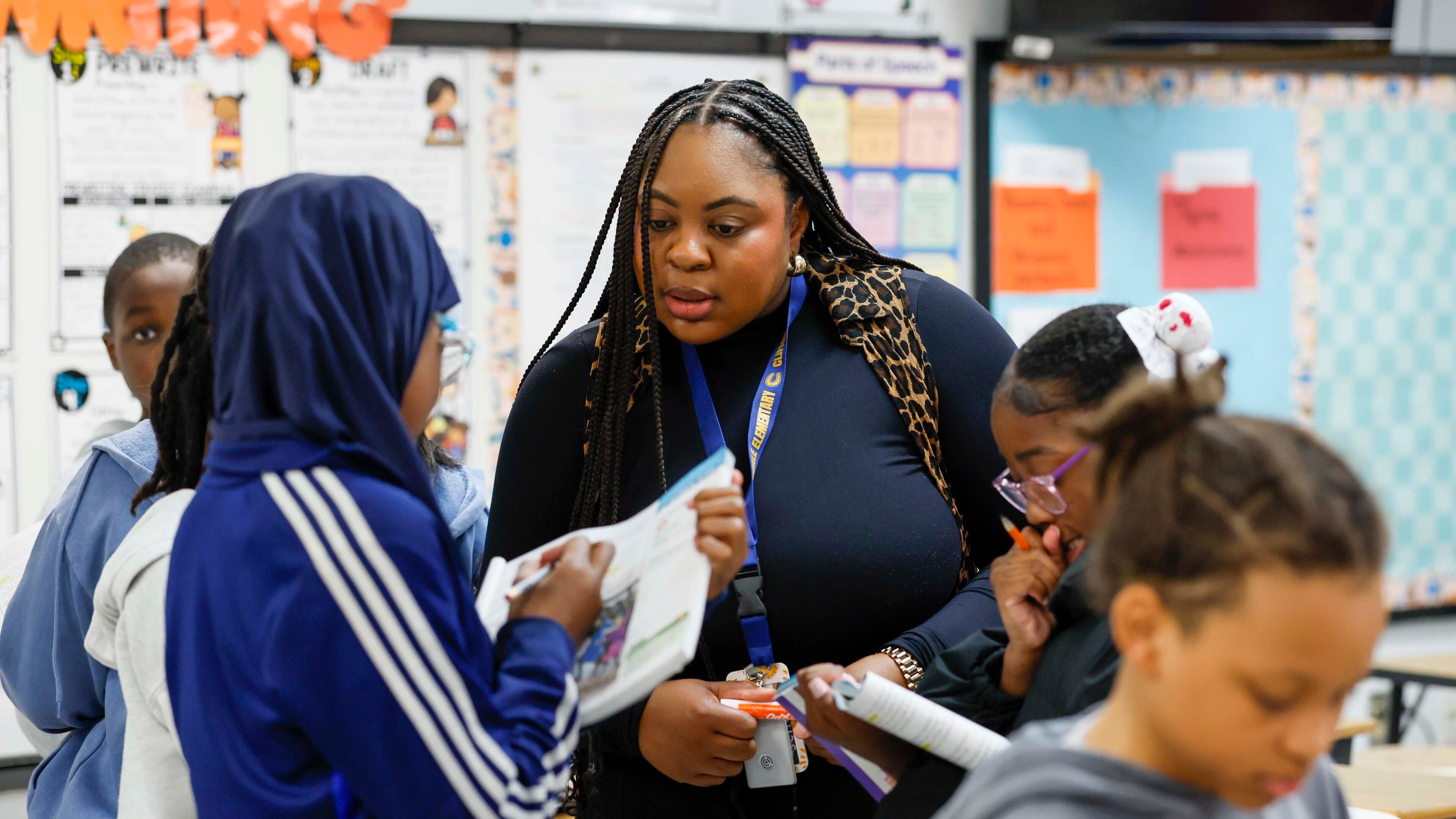 Elementary teacher Ashley Hill works with fifth grade students at Cliftondale Elementary in March. (Miguel Martinez/AJC)