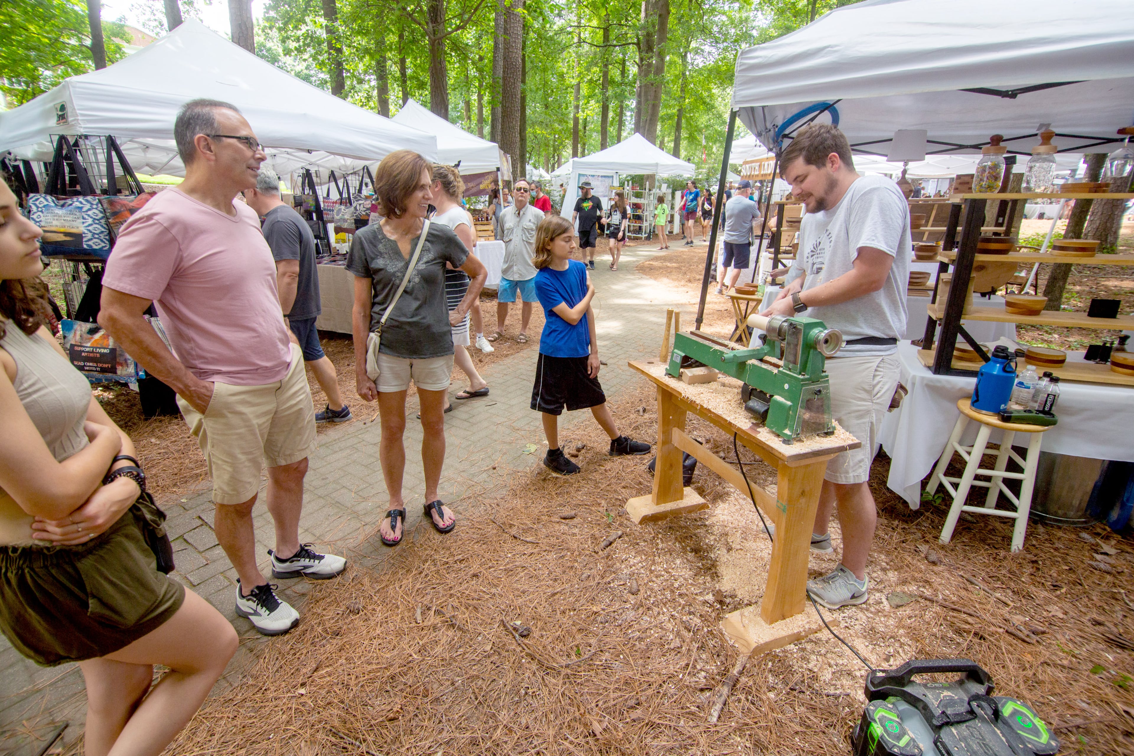 Cody Garrard gives a woodturning demonstration outside his artist tent during the Roswell Spring Arts and Crafts Festival on Sunday, June 13, 2021. (Photo: Steve Schaefer for The Atlanta Journal-Constitution)