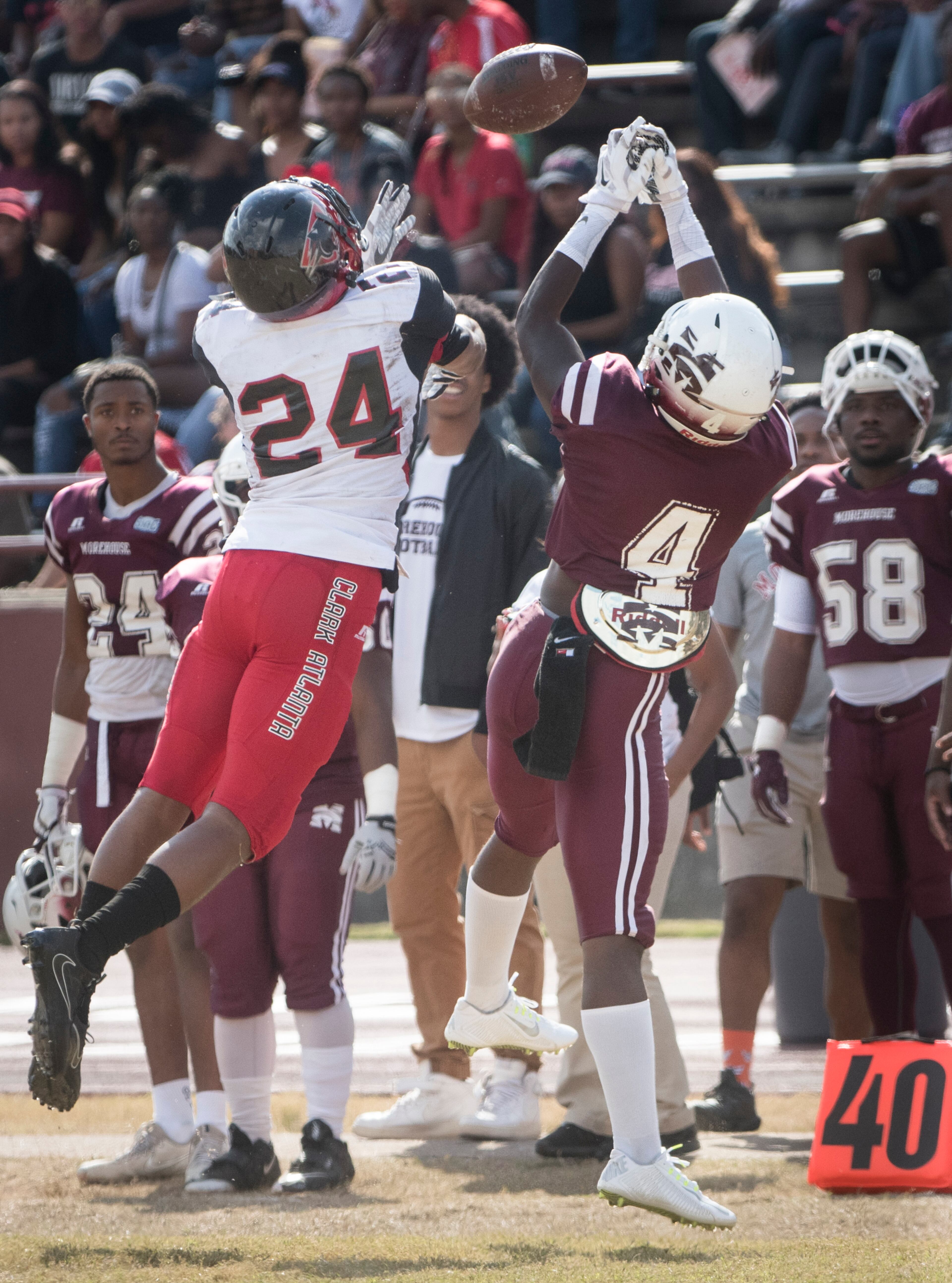 Clark Atlanta wide receiver Darryl Minor (24) and Morehouse defensive back Joshua Thurston (4) vie for a catch during a college football game on Saturday, Nov. 4, 2017, in Atlanta. (John Amis)