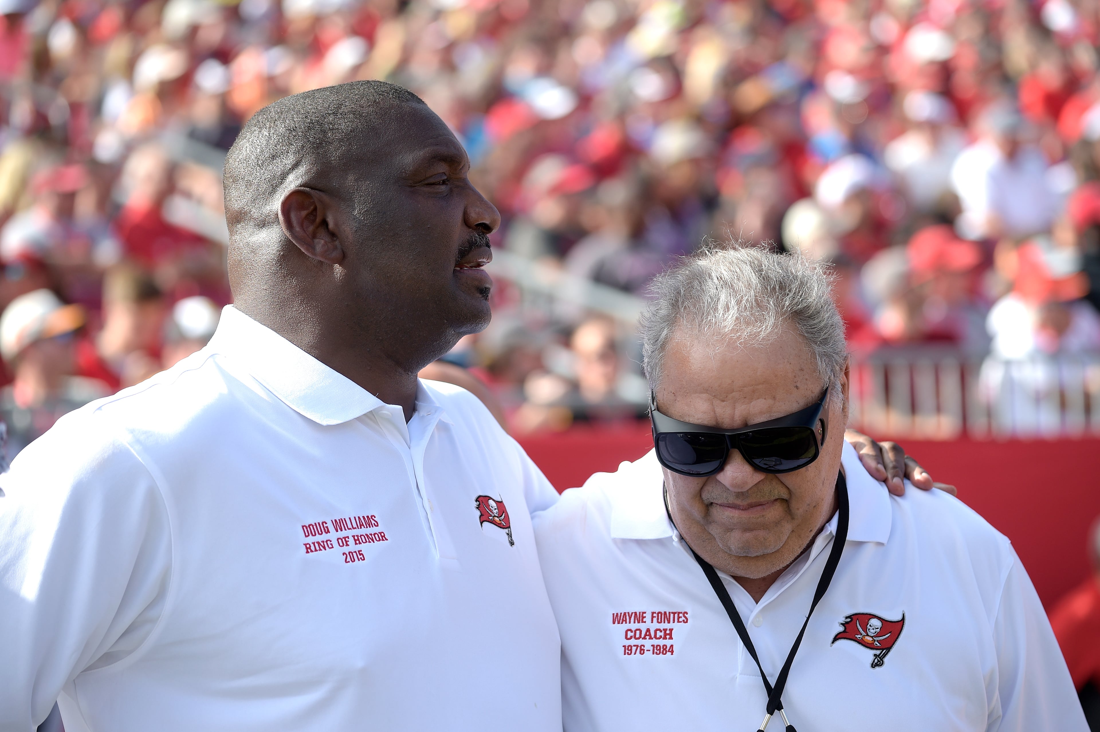 Former Tampa Bay Buccaneers quarterback Doug Williams, left, and coach Wayne Fontes chat on the sideline during the first half of an NFL football game against the Atlanta Falcons in Tampa, Fla., Sunday, Dec. 6, 2015. (AP Photo/Phelan M. Ebenhack)