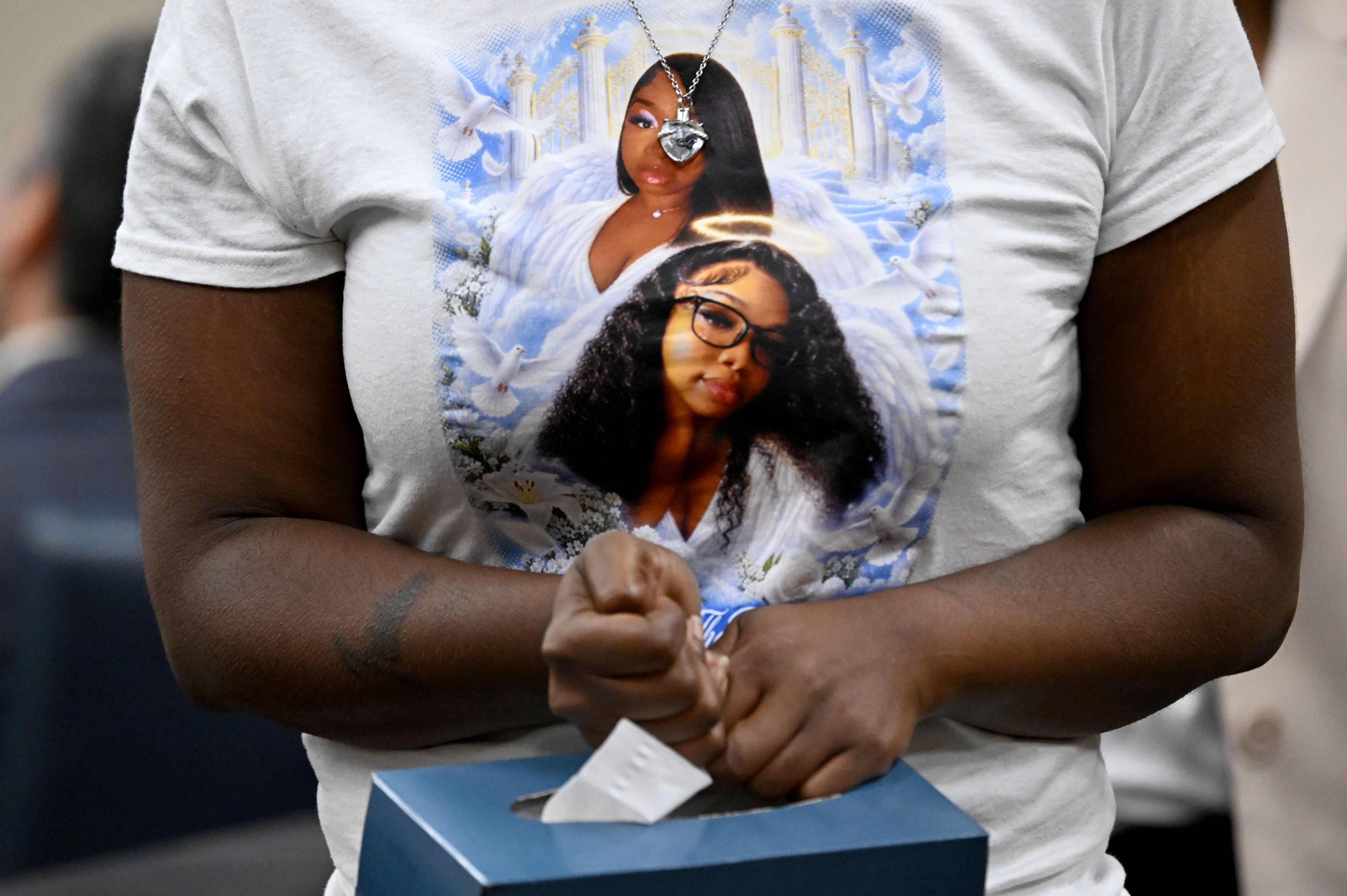 Jessica McCrary, the mother of Shanteria Mosley, who officials said was fatally shot and dismembered, wears a T-shirt printed with photos of her daughter during a hearing at the Cobb County Magistrate Court on Friday, Oct. 23, 2026, in Marietta. (Hyosub Shin/AJC)