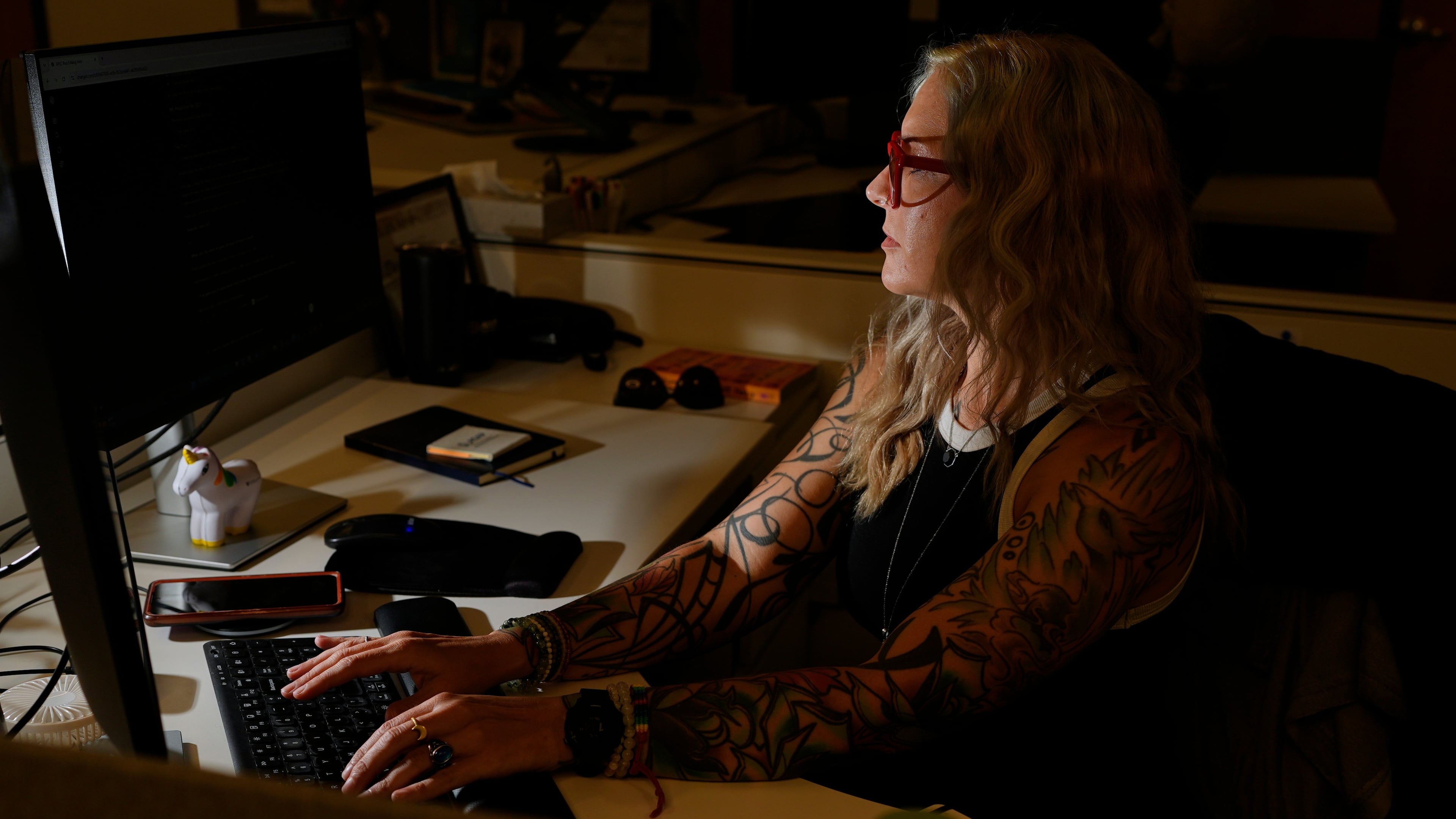 Deanna Danger types an AI prompt into her computer as she uses the technology to assist in her tasks as an administrative assistant at Vanderbilt University, Thursday, June 11, 2026, in Nashville, Tenn. (AP Photo/George Walker IV)