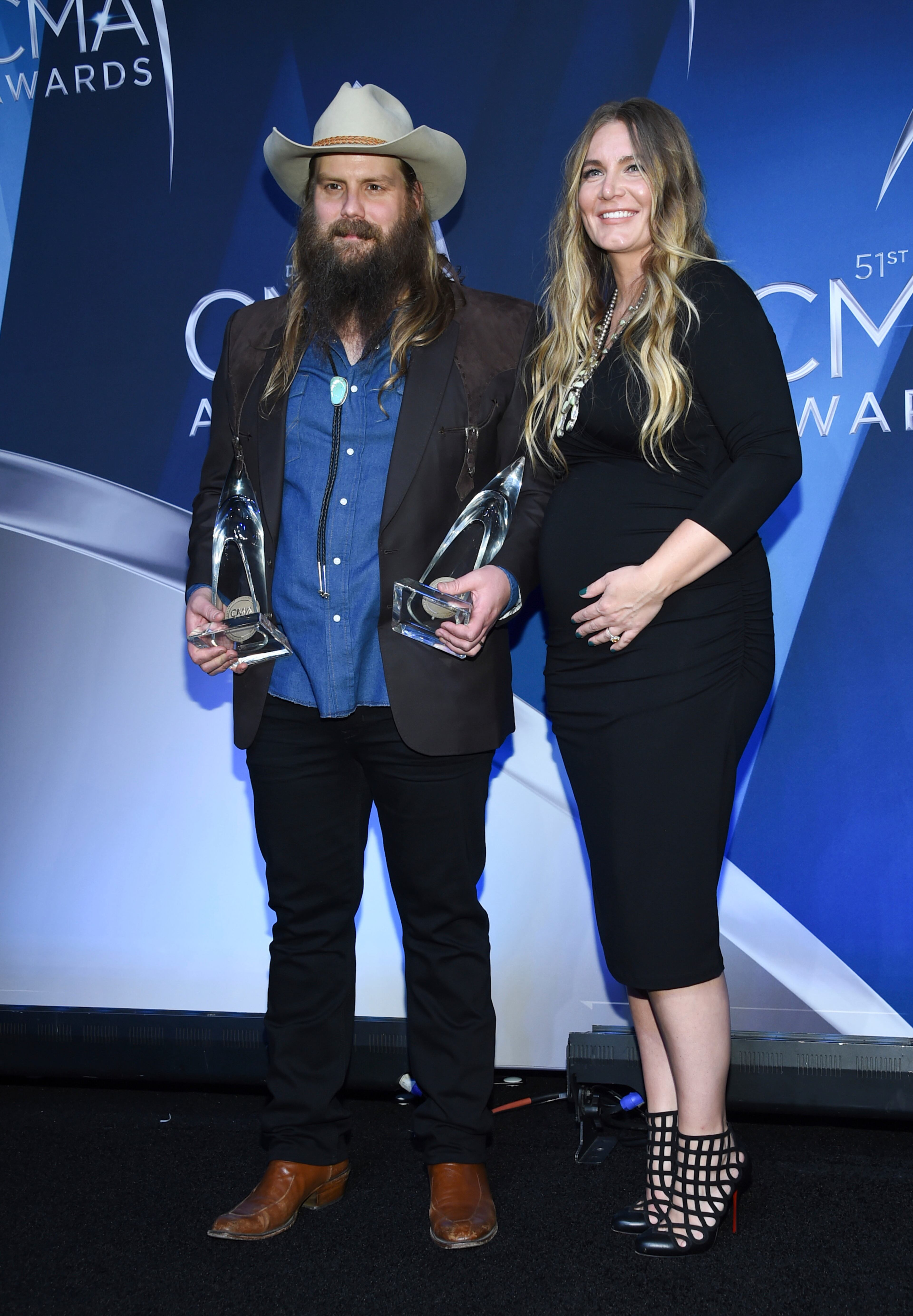 Musician Chris Stapleton and his wife Morgane Stapleton in the press room with the awards for album of the year and male vocalist of the year. (Photo by Evan Agostini/Invision/AP)