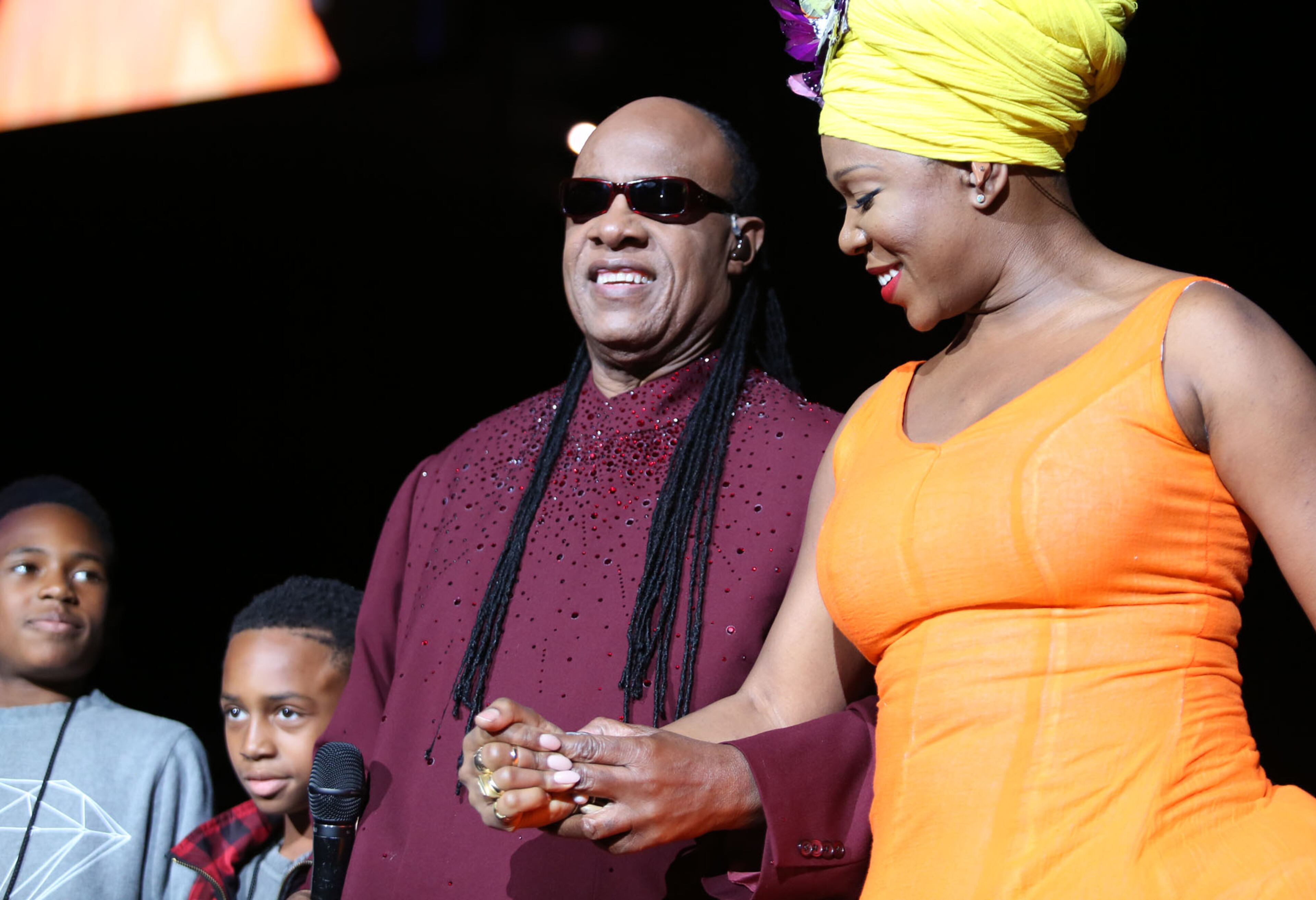 The legendary singer, musician, songwriter, Stevie Wonder, accompanied by two of his sons, is escorted on to the stage by Grammy Award winning singer, songwriter India Arie as he brings his tour celebrating his landmark album, "Songs in the Key of Life," to Atlanta, performing before a sold-out audience at the Philips Arena. (Akili-Casundria Ramsess/Special to the AJC)