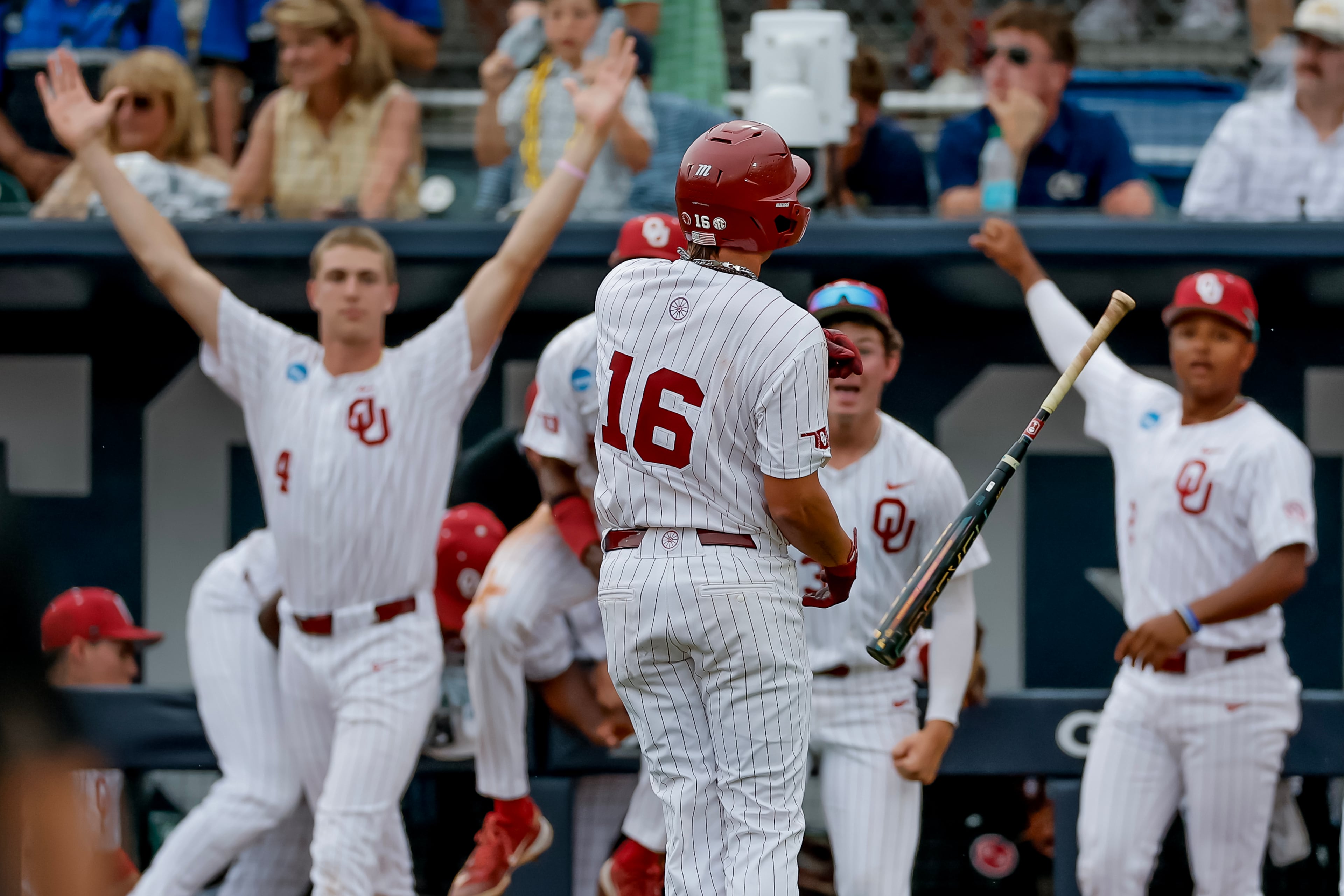 Oklahoma's Dayton Tockey (16) and teammates celebrate after Tockey hit a solo home run against Georgia Tech during the 10th inning to win the Atlanta Regional elimination baseball game at Russ Chandler Stadium, Monday, June 1, 2026, in Atlanta. (Erik S. Lesser for the AJC)