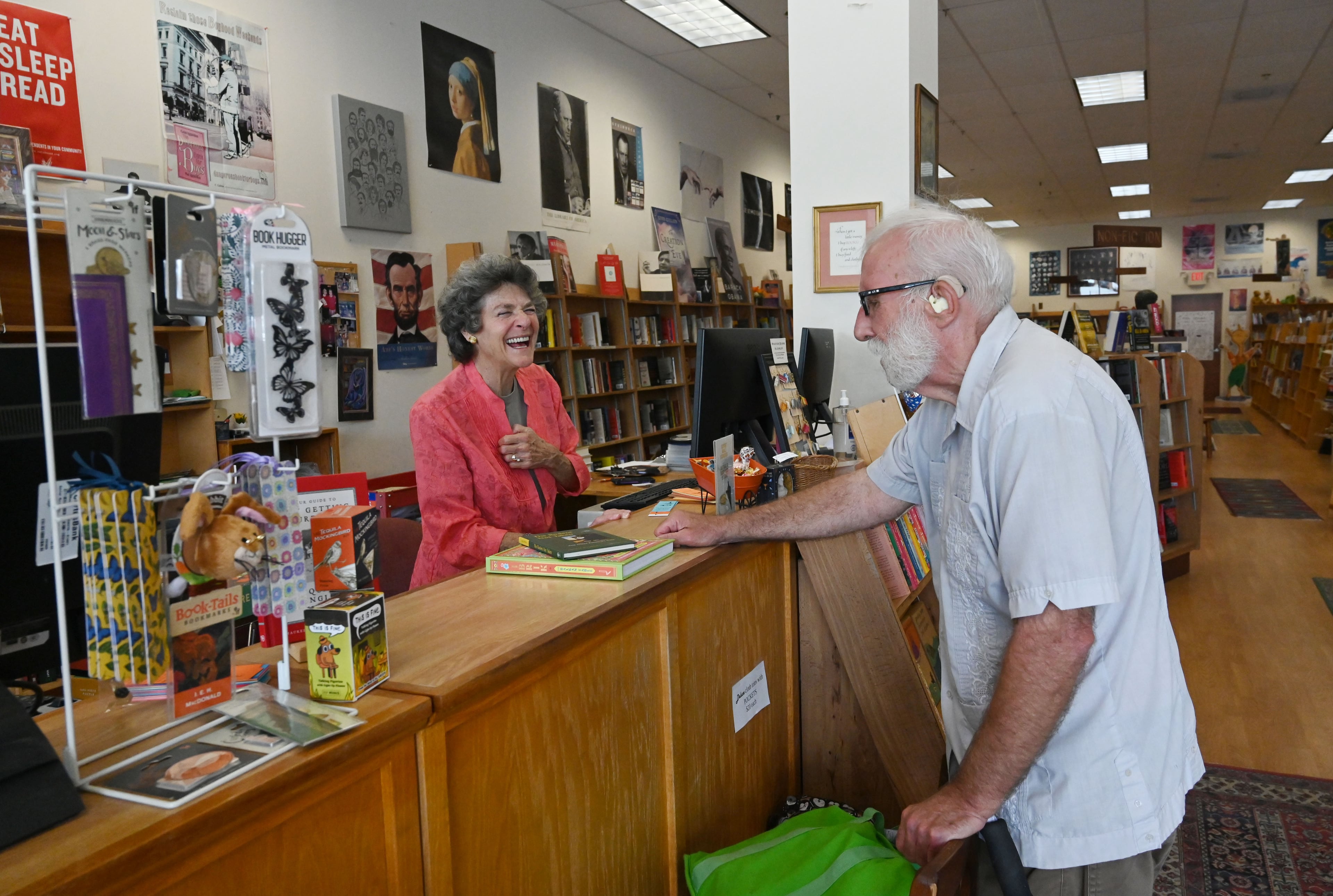 Eve Shulmister, left, a longtime, beloved bookseller at Tall Tales Book Shop, helps customer Dan Boles on Wednesday, July 8, 2026, in Atlanta. The 46-year-old bookstore will face new competition this summer when a Barnes & Noble opens in an adjacent shopping center. (Hyosub Shin/AJC)