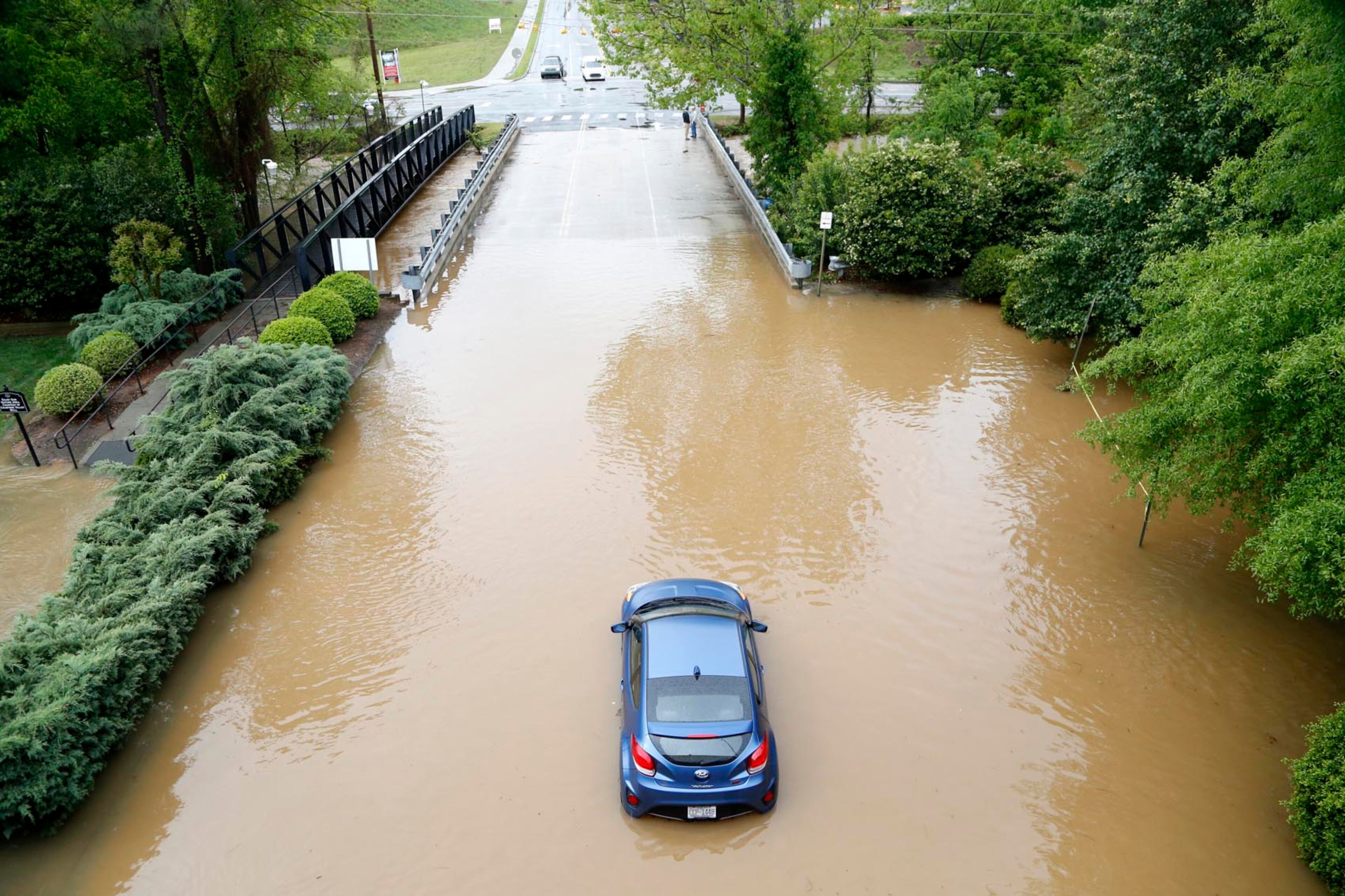 One vehicle lies stranded by the bridge leading into the back side of Crabtree Valley Mall in Raleigh, N.C., on Tuesday, April 25, 2017, amid heavy rain in the area. (Chris Seward/Raleigh News & Observer/TNS)