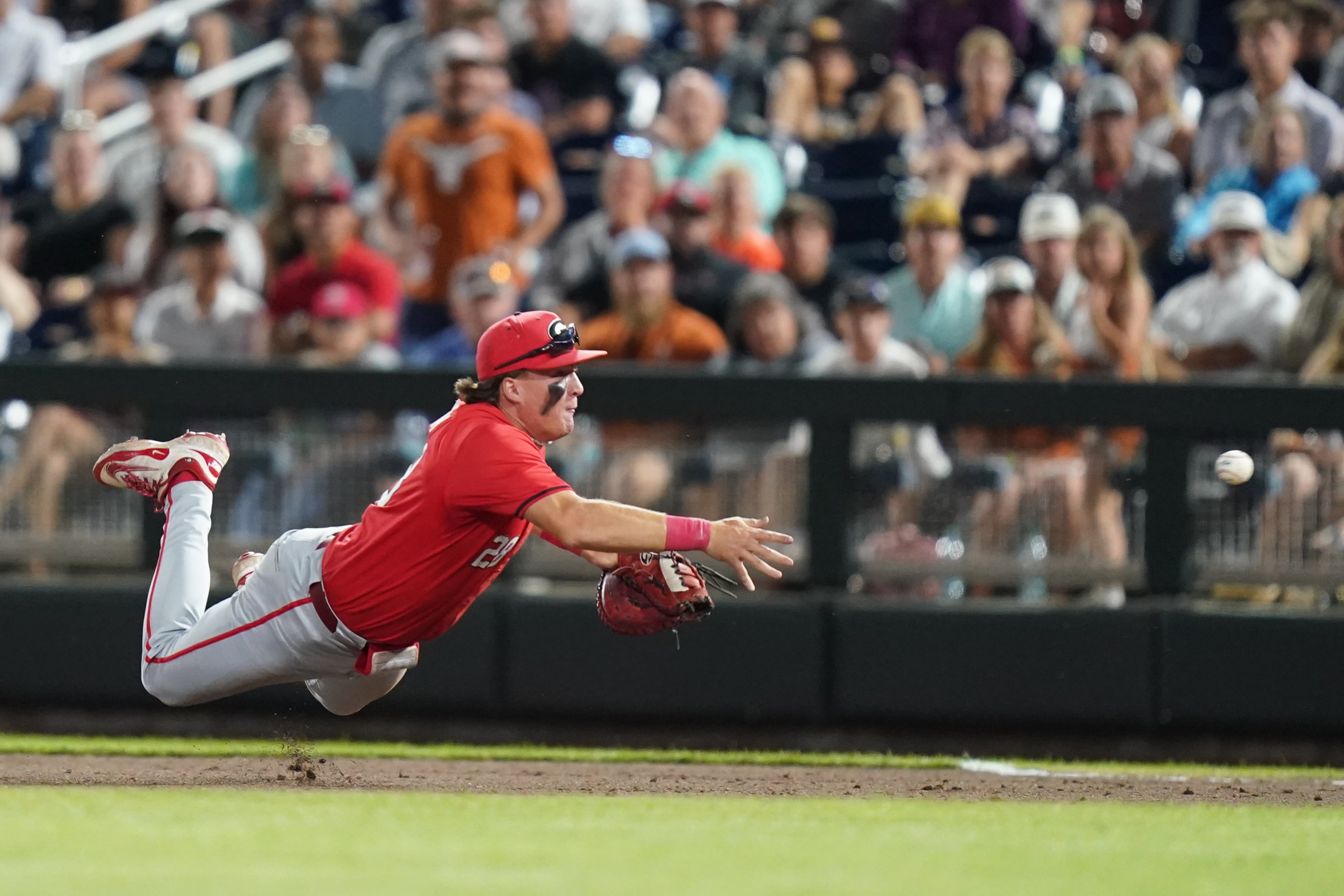 Georgia infielder Brennan Hudson (28) makes a diving play during an NCAA baseball College World Series elimination game against Texas, Tuesday, June 16, 2026 in Omaha, Neb. Georgia won 2-0. (AP Photo/Vera Nieuwenhuis)