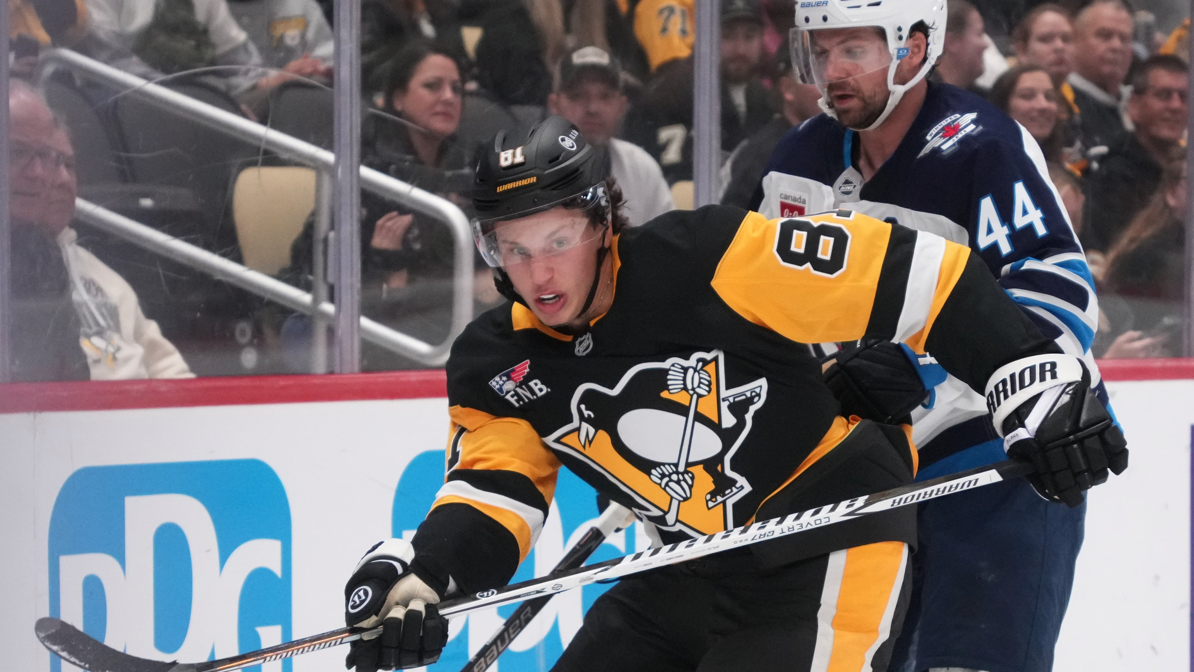 Pittsburgh Penguins' Ben Kindel (81) is defended by Winnipeg Jets' Josh Morrissey (44) during the second period of an NHL hockey game in Pittsburgh, Monday, Oct. 5, 2026. (AP Photo/Gene J. Puskar)