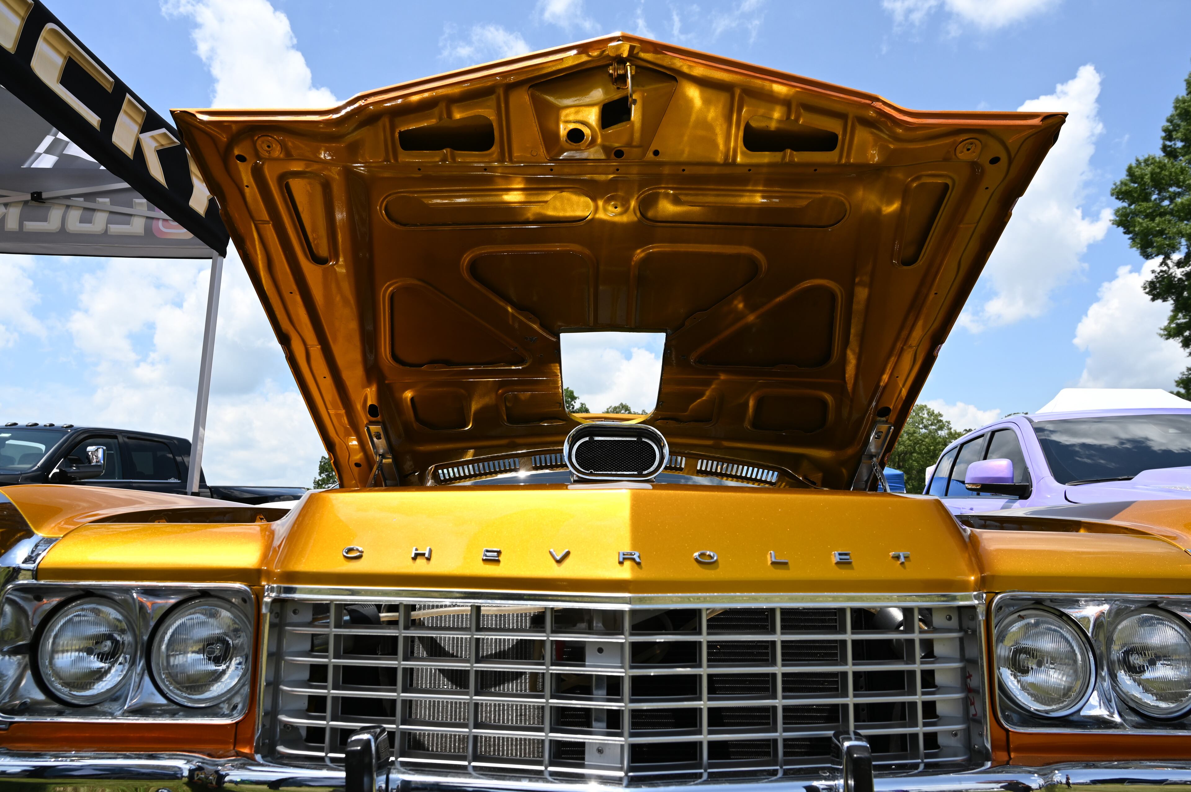 Attendees walk through some of classic/custom and luxury vehicles on Rick Ross’s property during the 4th Annual Rick Ross Car and Bike Show, Saturday, June 7, 2025, in Fayetteville. The 4th Annual Rick Ross Car and Bike Show will include a vendor market with more than 30 vendors, food trucks, fleets of classic/custom automobiles, luxury vehicles, boats, RVs and trailers on the front of the mansion. Stage performances include Plies, Ross' new signee Nino Breeze and Ross himself. (Hyosub Shin / AJC)