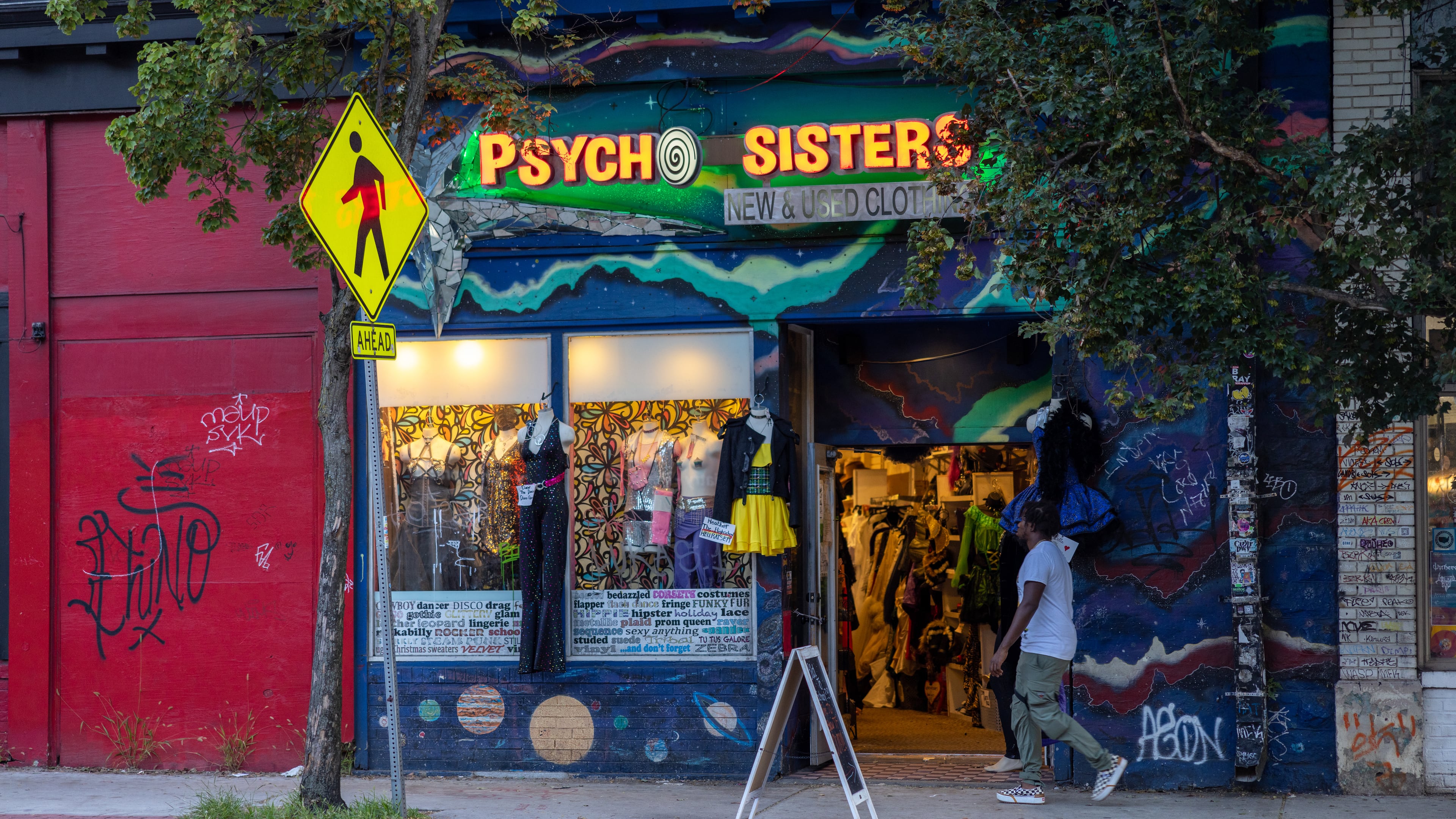 Man walks by Psycho Sisters in Little 5 Points on August 20, 2022