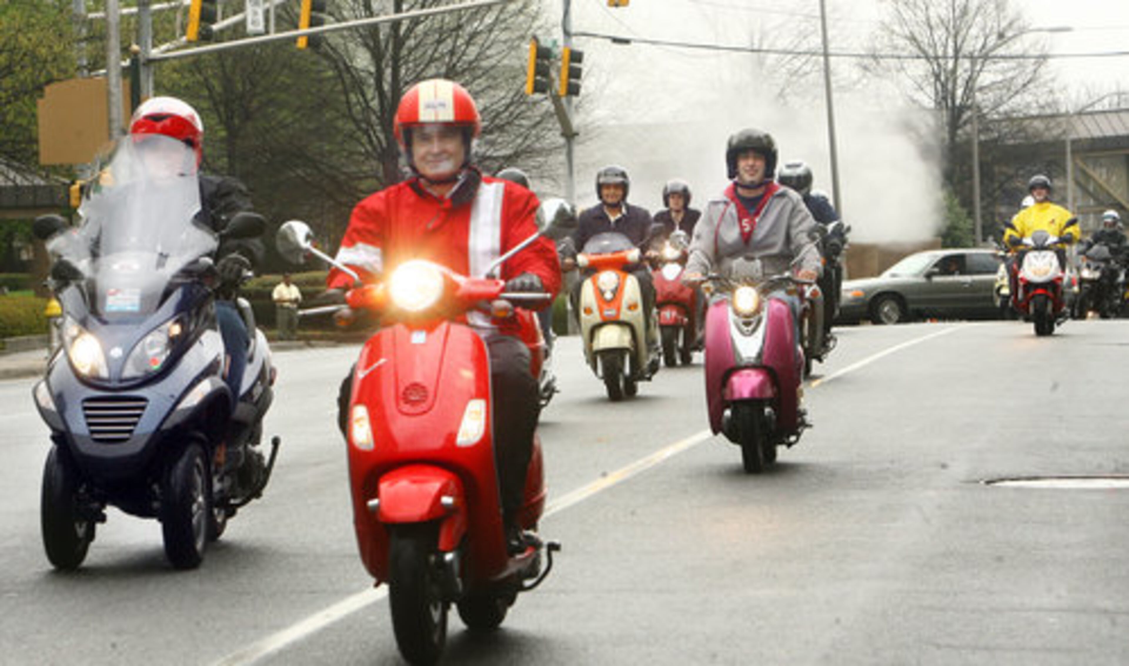 Scooter enthusiasts from around metro Atlanta ride along Martin Luther King Jr. Drive as they arrive at the Capitol to celebrate the second annual Atlanta Scooter Commuter Day.