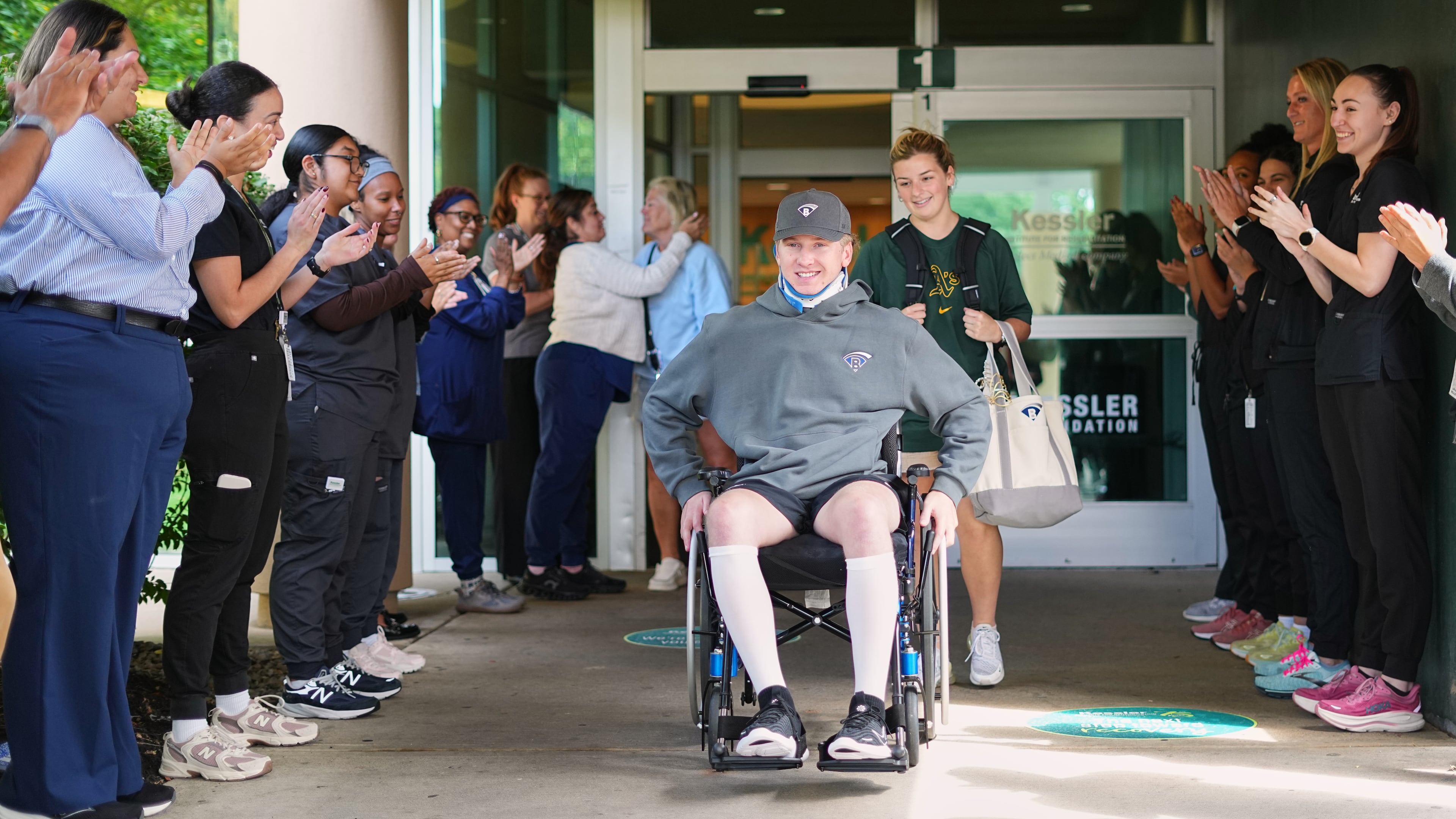 Caregivers clap out Ryan Lasko, a minor league prospect with the Athletics who was paralyzed in an outfield collision more than two months ago, upon his discharge from Kessler Institute for Rehabilitation in West Orange, N.J., Wednesday, Sept. 16, 2026. (AP Photo/Matt Rourke)