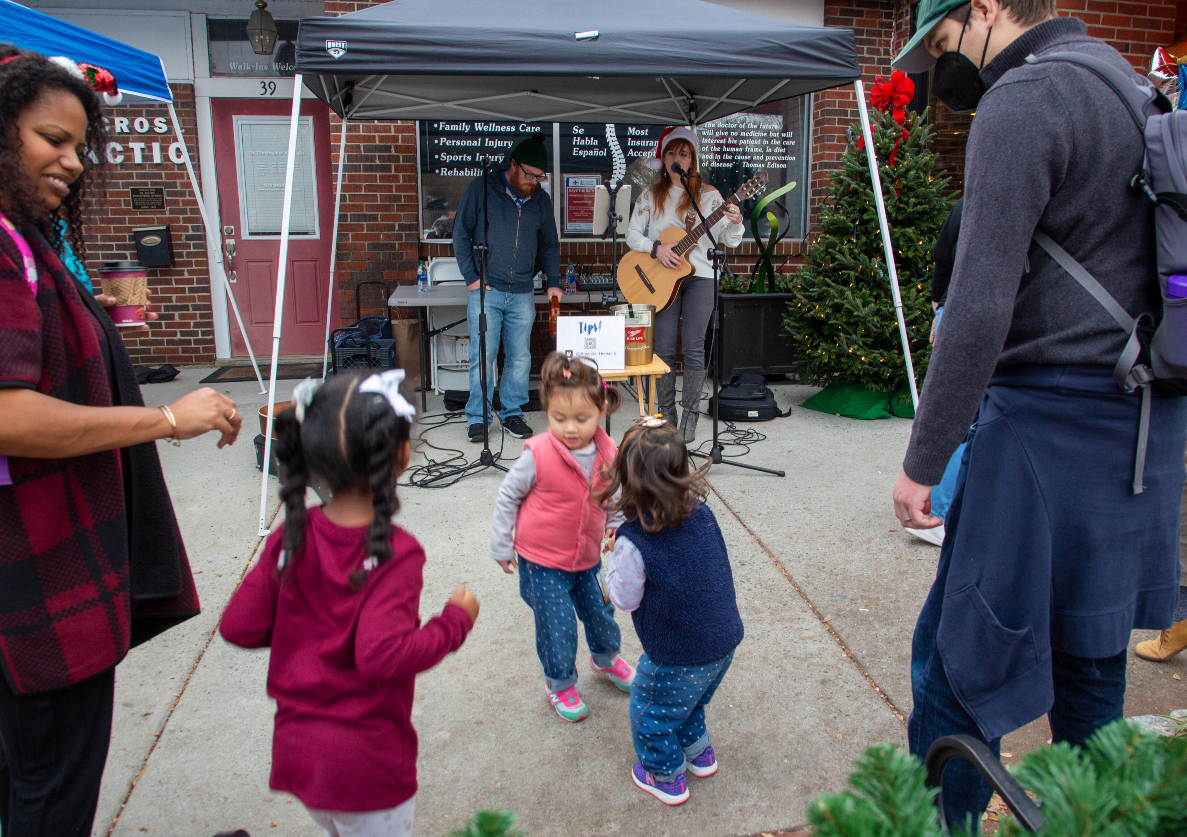 Kids dance to live music during the Christmas Village weekend event in historic downtown Norcross on Sunday, December 5, 2021. (Photo: Steve Schaefer for The Atlanta Journal-Constitution)