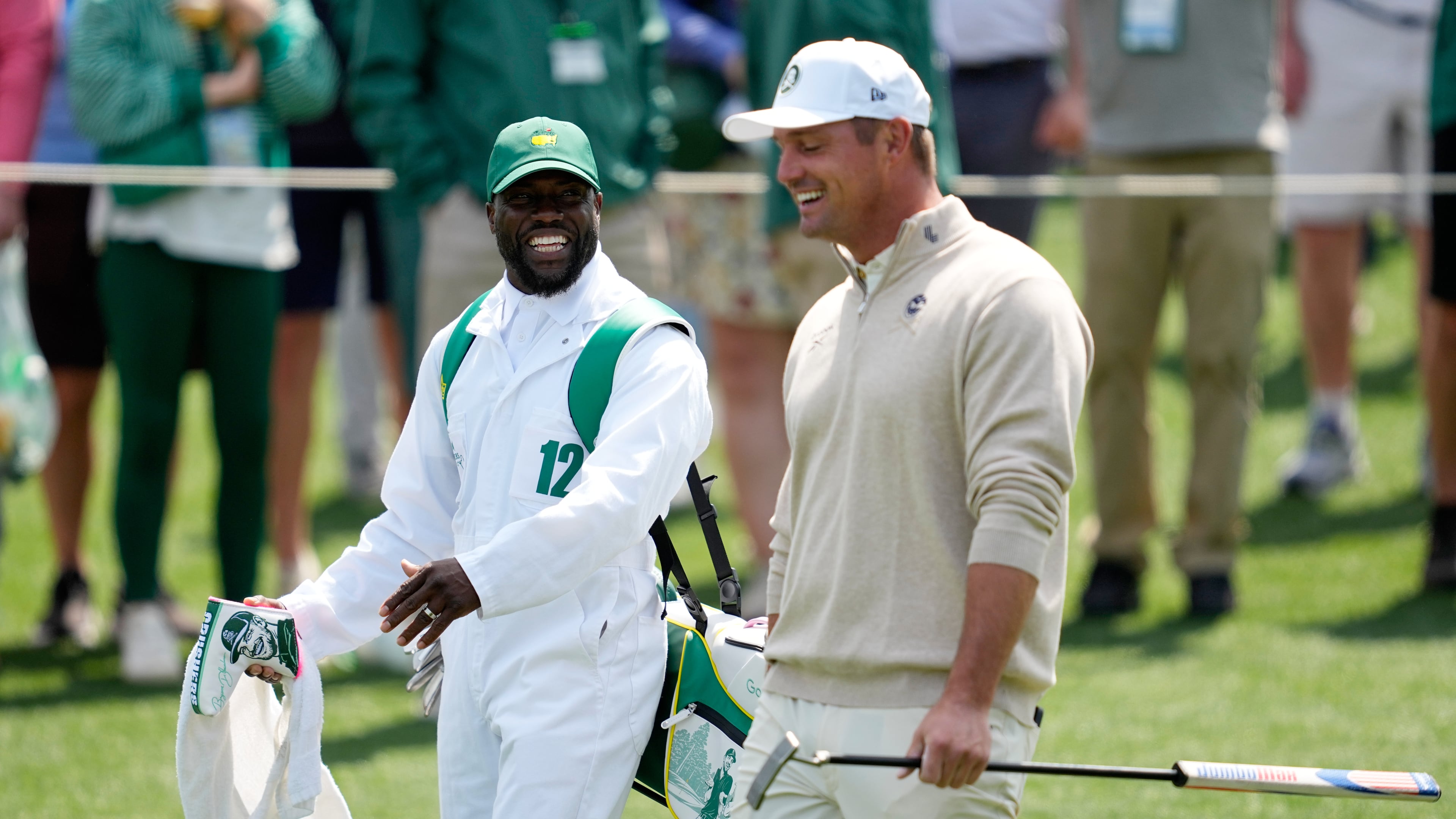 Actor Kevin Hart, left, and Bryson DeChambeau laugh during par-3 contest ahead of the Masters golf tournament at the Augusta National Golf Club, Wednesday, April 8, 2026, in Augusta, Ga. (AP Photo/Ashley Landis)
