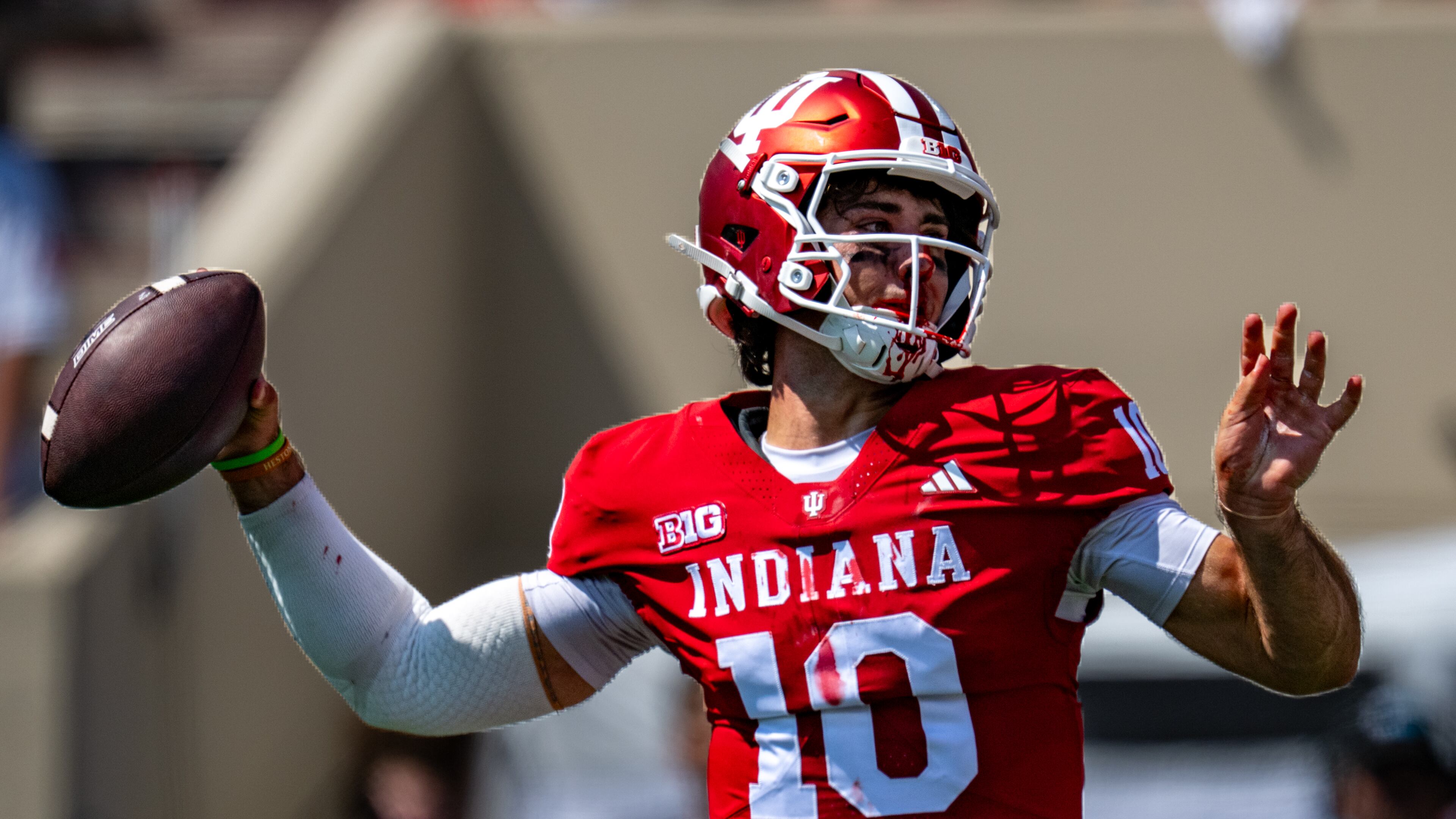 A bloodied Indiana quarterback Josh Hoover (10) looks to pass during the first half of an NCAA college football game against North Texas, Saturday, Sept. 5, 2026, in Bloomington, Ind. (AP Photo/Doug McSchooler)