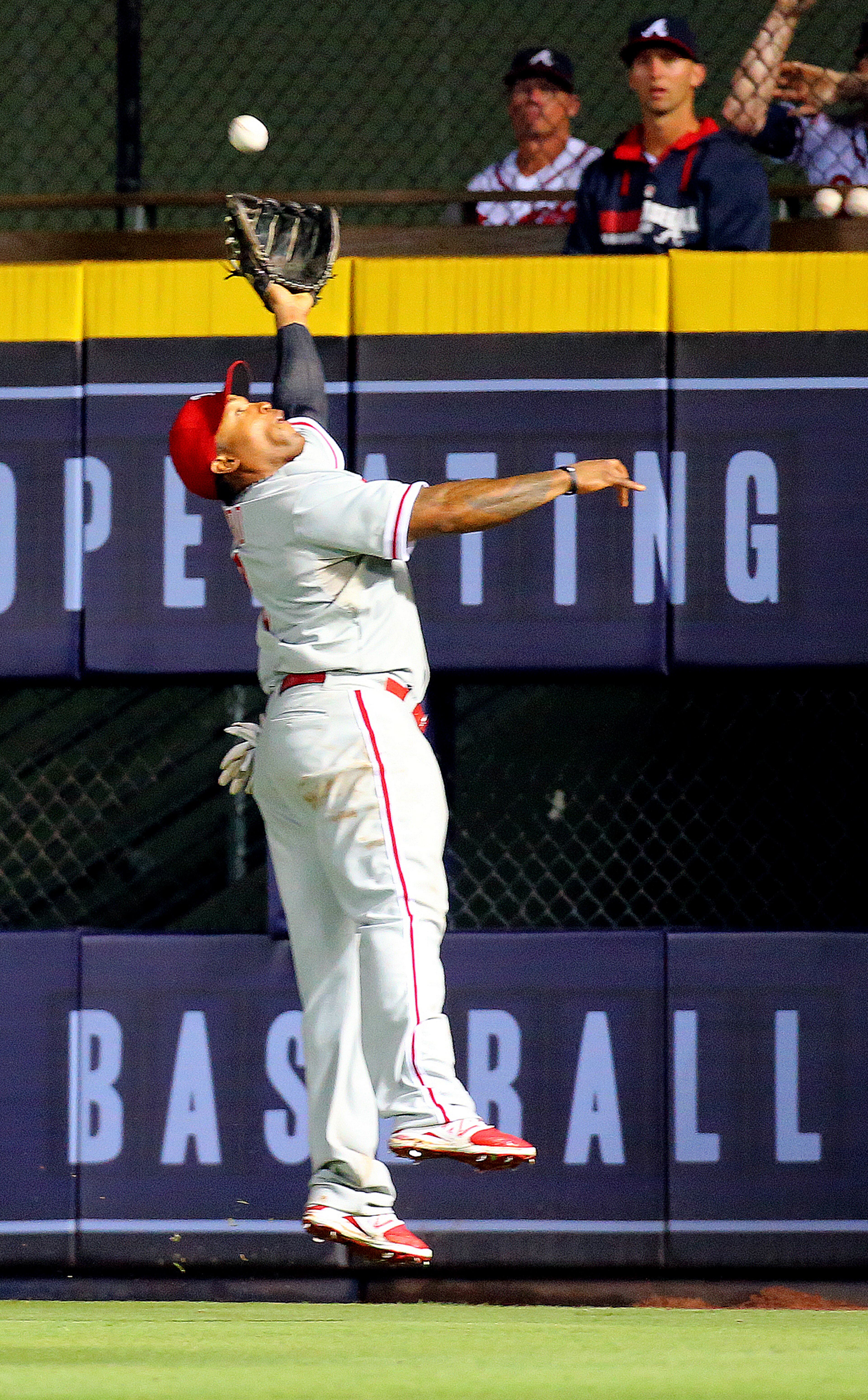 Phillies Marlon Byrd makes a running leaping catch for the out on a fly ball to right field by Braves Tommy La Stella during the seventh inning in a baseball game on Tuesday, Sept. 2, 2014, in Atlanta. CURTIS COMPTON / CCOMPTON@AJC.COM