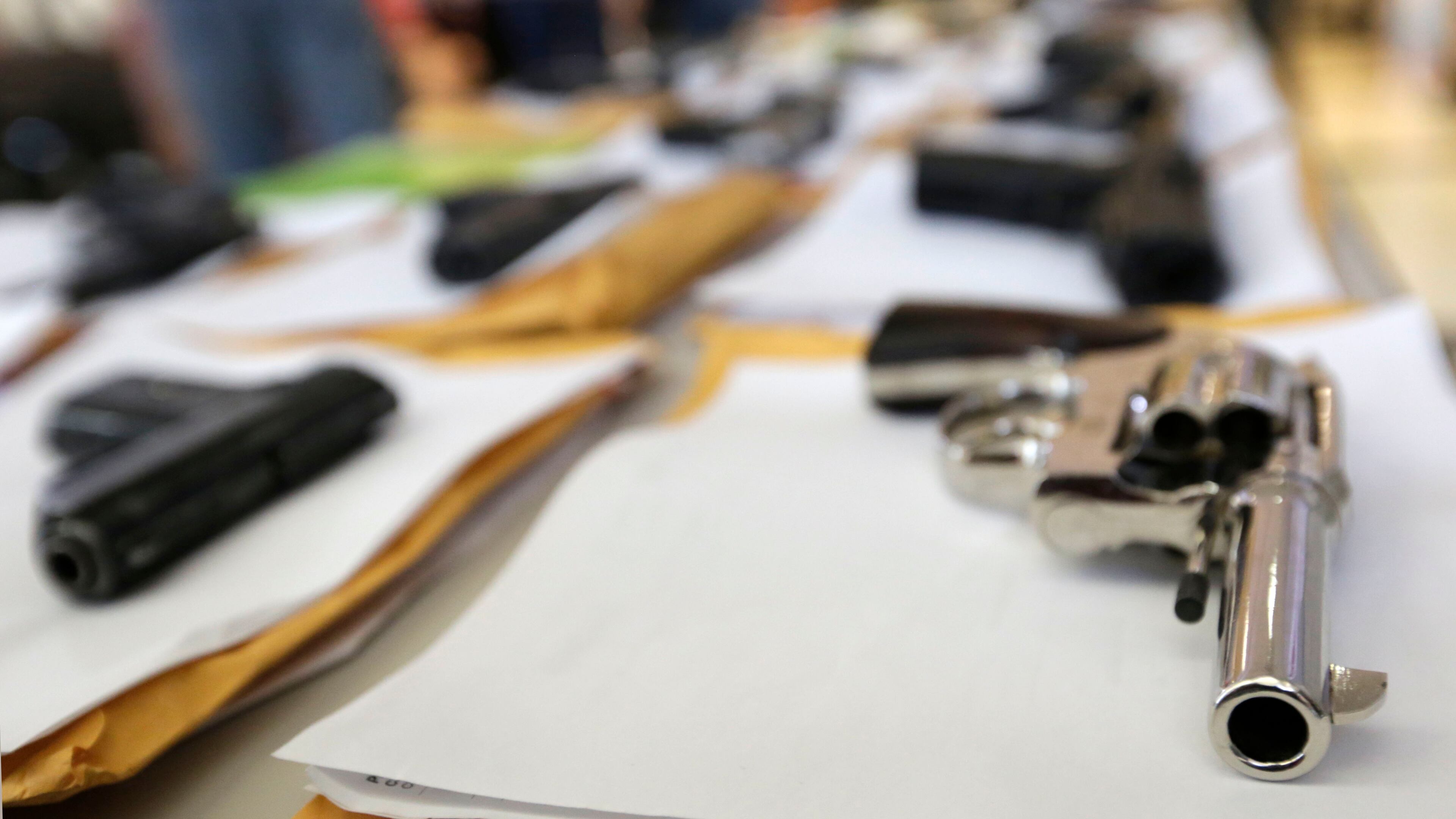 Chicago police display some of the guns they had seized as of July 7, 2014. That city is on pace this year to exceed its number of shootings last year by almost 500. (AP file photo)