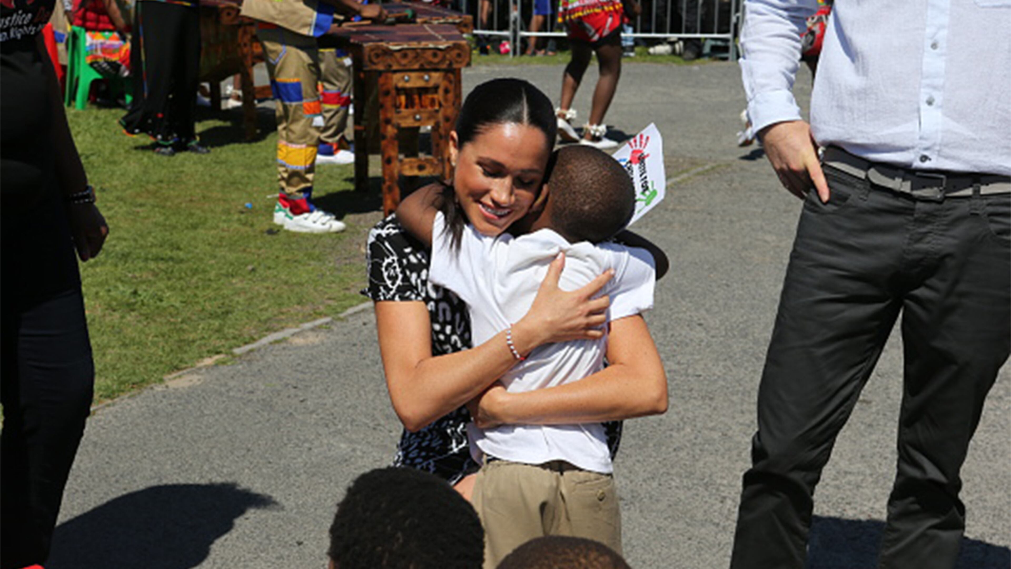 CAPE TOWN, SOUTH AFRICA - SEPTEMBER 23: Meghan, Duchess of Sussex hugs a wellwisher during a visit to The Justice Desk on September 30, 2019 in Cape Town, South Africa. The Justice Desk initiative teaches children about their rights and provides self-defence classes and female empowerment training to young girls in the community. (Photo by Ian Vogler - Pool/Getty Images)