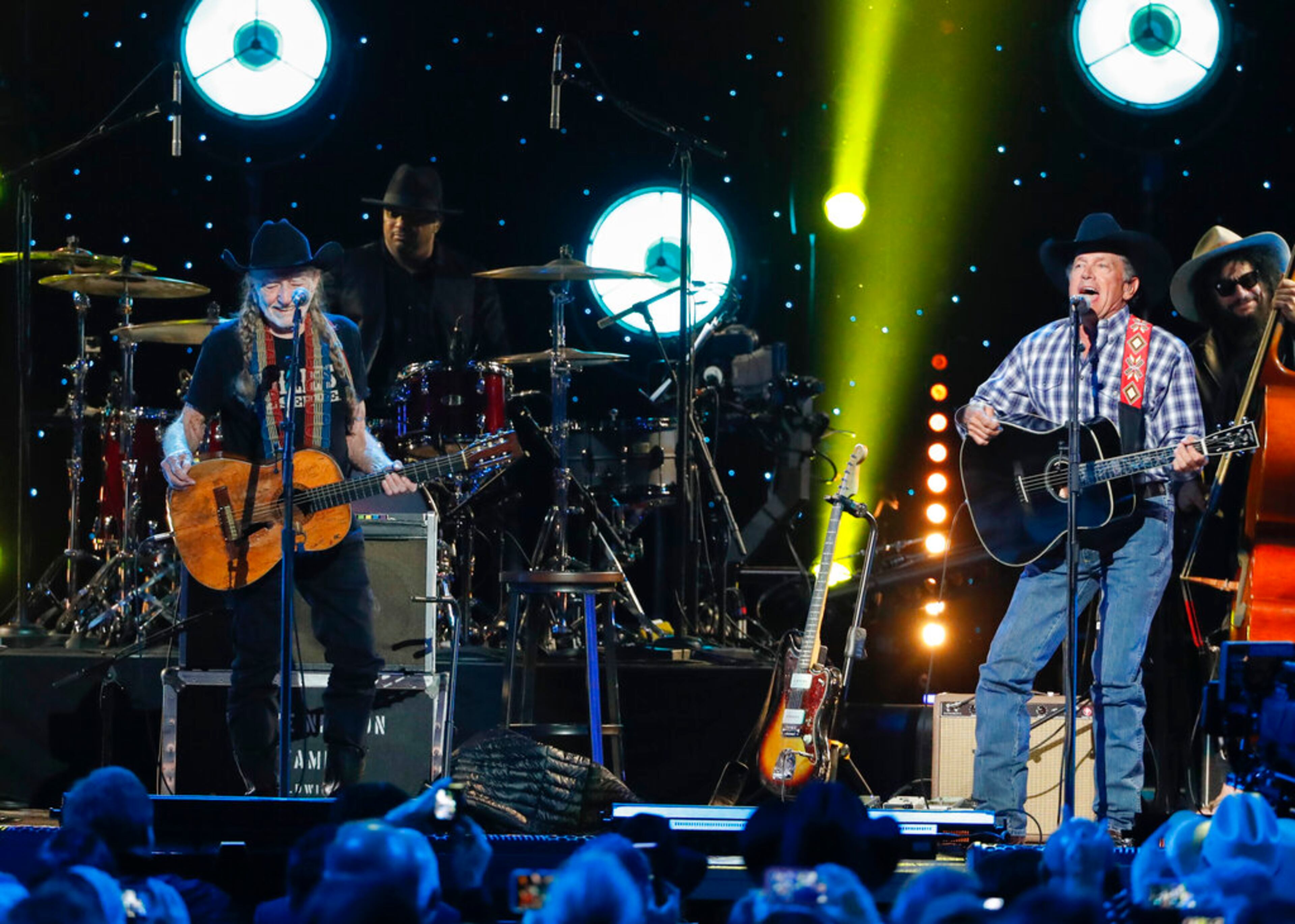 Willie Nelson, left, and George Strait perform at Willie: Life & Songs Of An American Outlaw at Bridgestone Arena on Saturday, Jan. 12, 2019, in Nashville, Tenn. (Photo by Al Wagner/Invision/AP)